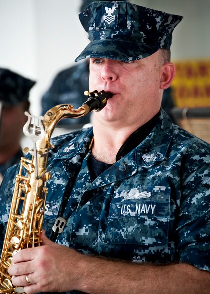 A petty officer 1st class from the Navy Band of New Orleans, plays a tune on the saxophone prior to the 33rd Maintenance Group change of command, July 22 at Eglin Air Force Base, Fla.  (U.S. Air Force photo/Samuel King Jr.)