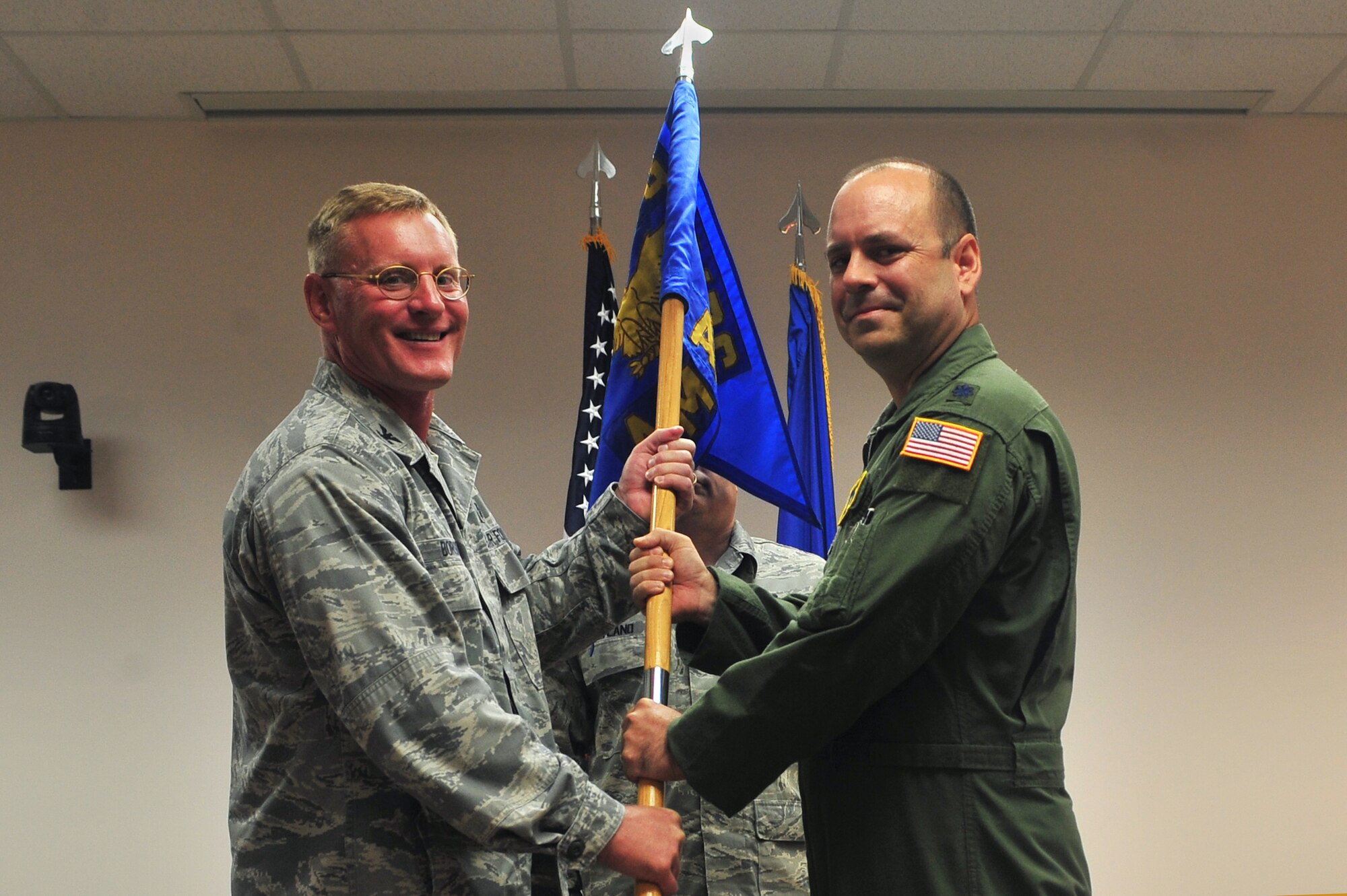 U.S. Air Force Col. Dean Borsos, 20th Medical Group commander, presents the squadron guide-on to Lt. Col. Scott Hartwich at the 20th Aerospace Medicine Squadron change of command, Shaw Air Force Base, S. C. July 28, 2011.The passing of the guide-on is a ceremony to allow the previous commander to hand over his previous responsibilities as commander. (U.S. Air Force photo by Airman 1st Class Ashley Gardner/ Released)