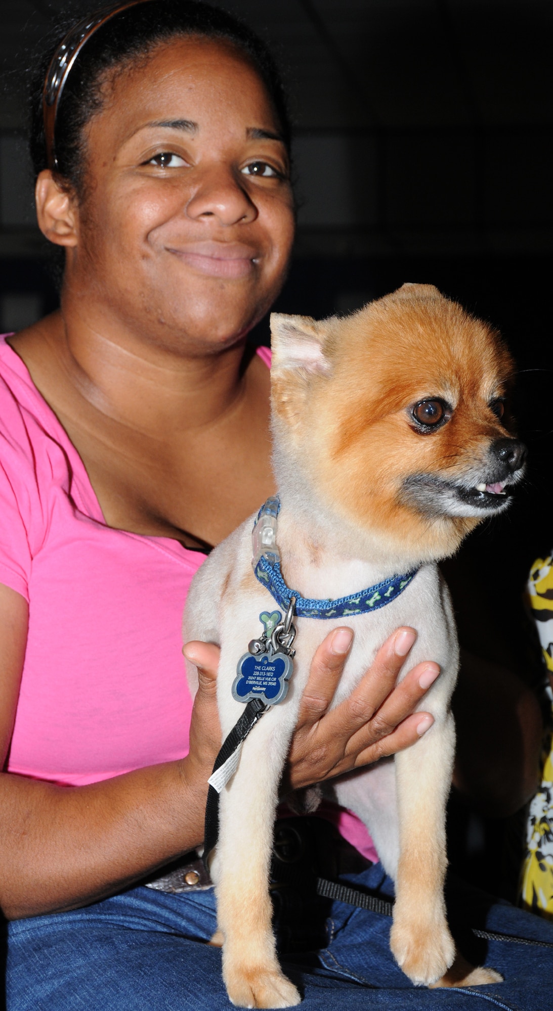 Dewi Clark, 81st Communications Squadron, holds her pet pomeranian, Chewy, during a Strut Your Mutt event at the Vandenberg Community Center July 22.  (U.S. Air Force photo by Kemberly Groue)