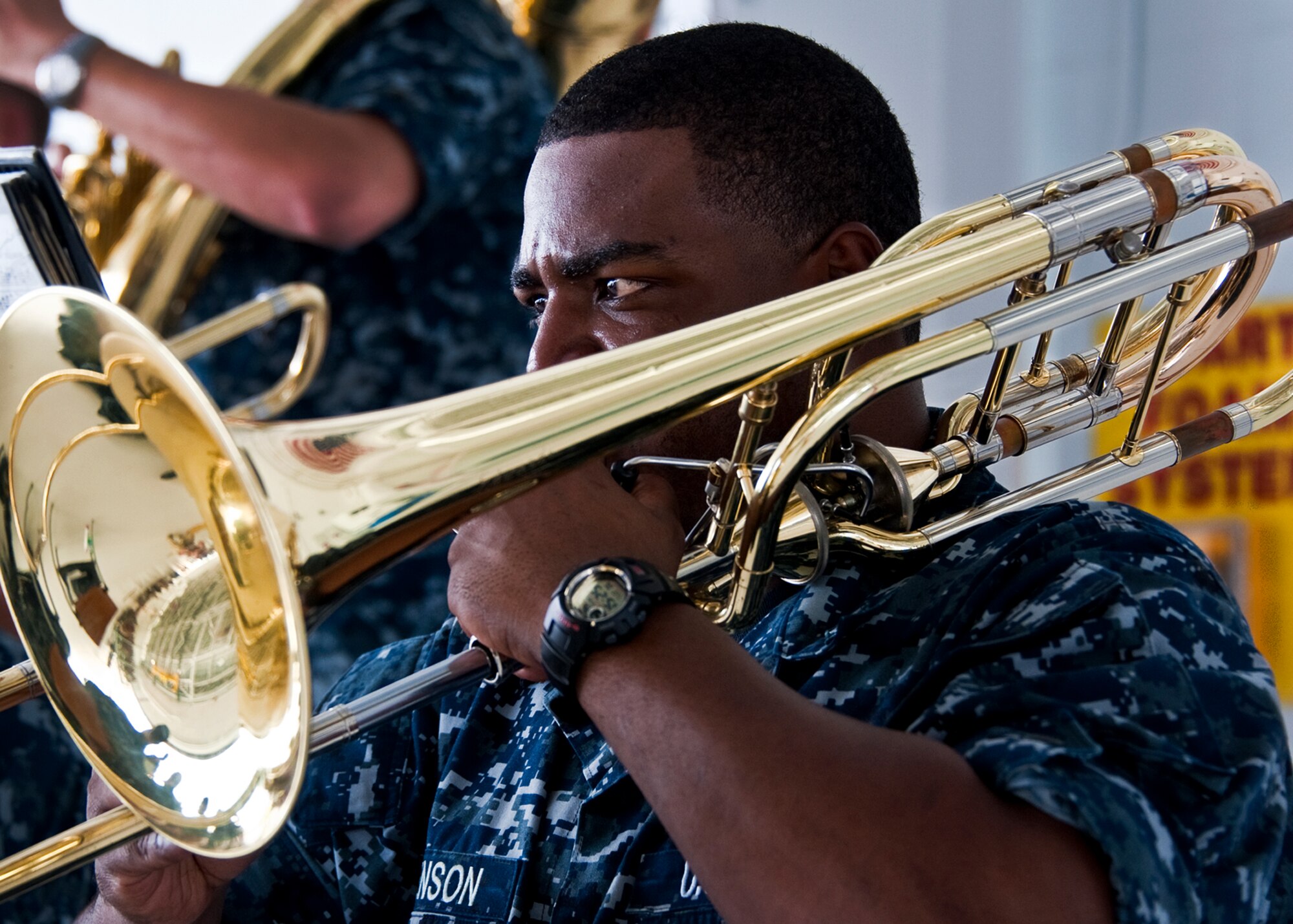 A trombonist from the Navy Band of New Orleans, plays a tune prior to the 33rd Maintenance Group change of command, July 22 at Eglin Air Force Base, Fla.  (U.S. Air Force photo/Samuel King Jr.)