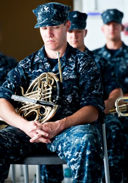 A petty officer 2nd class, with the Navy Band of New Orleans, waits for the next song during the 33rd Maintenance Group change of command, July 22 at Eglin Air Force Base, Fla.  (U.S. Air Force photo/Samuel King Jr.)