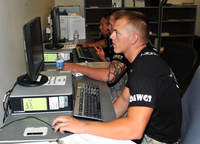 Airmen input data into an electronic database, July 27, 2011 at Joint Base Lewis-McChord, Wash., during an in-transit visibility competition. The event was part of Air Mobility Rodeo 2011, a biennial international competition that focuses on mission readiness, featuring airdrops, aerial refueling and other events that showcase the skills of mobility crews from around the world. (U.S. Air Force photo/Airman 1st Class Jared Trimarchi) 
