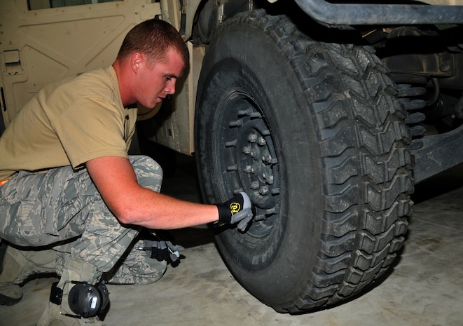 An Airman replaces a cap after checking the tire pressure of a Humvee, July 27, 2011 at Joint Base Lewis-McChord, Wash., during a joint inspection competition. The event was part of Air Mobility Rodeo 2011, a biennial international competition that focuses on mission readiness, featuring airdrops, aerial refueling and other events that showcase the skills of mobility crews from around the world. (U.S. Air Force photo/Airman 1st Class Jared Trimarchi) 
