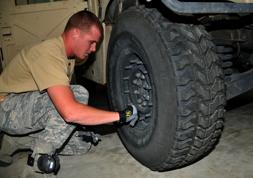 An Airman replaces a cap after checking the tire pressure of a Humvee, July 27, 2011 at Joint Base Lewis-McChord, Wash., during a joint inspection competition. The event was part of Air Mobility Rodeo 2011, a biennial international competition that focuses on mission readiness, featuring airdrops, aerial refueling and other events that showcase the skills of mobility crews from around the world. (U.S. Air Force photo/Airman 1st Class Jared Trimarchi) 