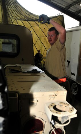 An Airman calculates the height of a Humvee, July 27, 2011 at Joint Base Lewis-McChord, Wash., during a joint inspection competition. The event was part of Air Mobility Rodeo 2011, a biennial international competition that focuses on mission readiness, featuring airdrops, aerial refueling and other events that showcase the skills of mobility crews from around the world. (U.S. Air Force photo/Airman 1st Class Jared Trimarchi) 