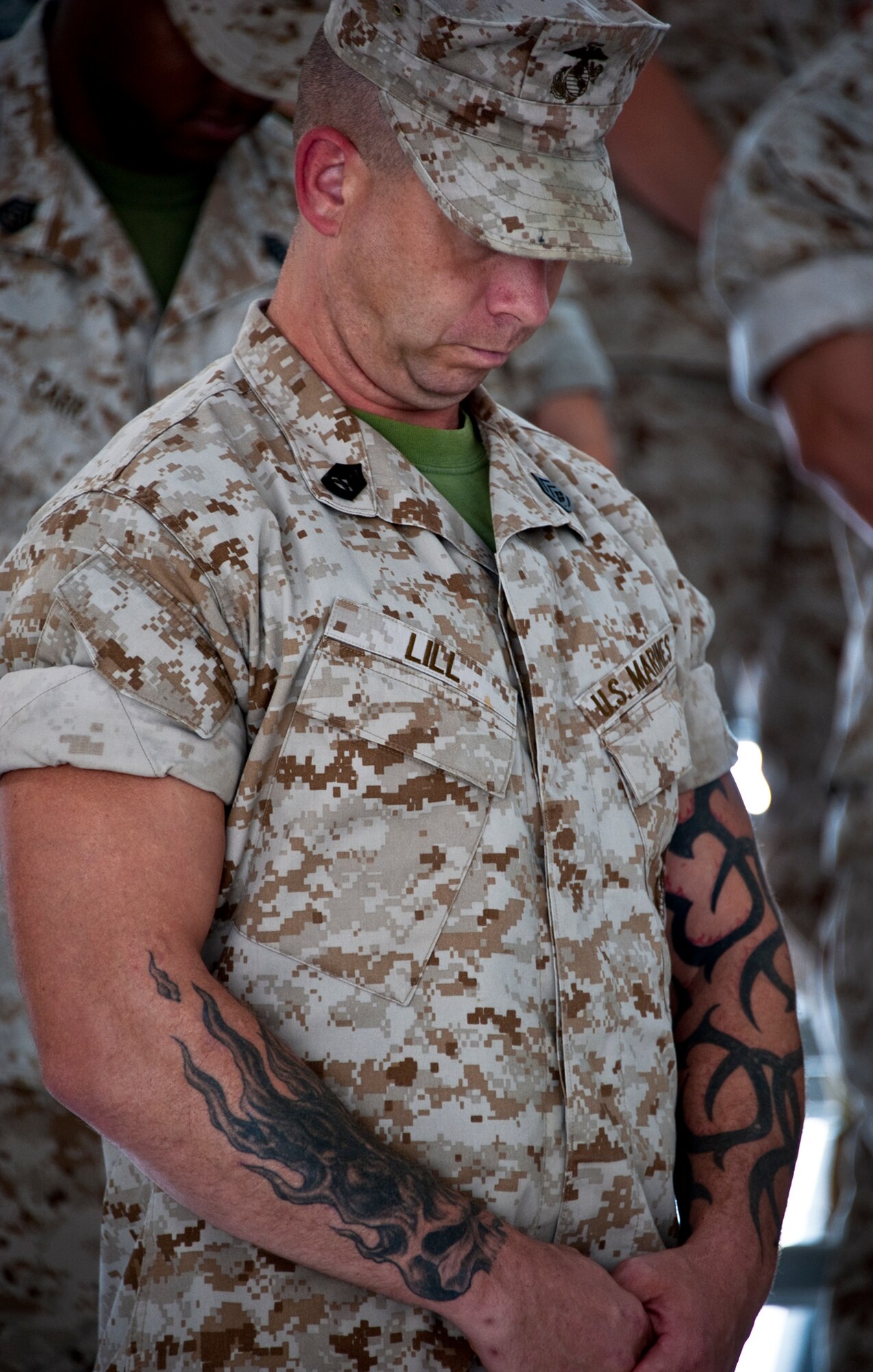Gunnery Sgt. Markus Lill, from the Marine Fighter Attack Training Squadron 501, bows his head during the invocation at the 33rd Maintenance Group change of command, July 22 at Eglin Air Force Base, Fla.  The 501st is the Marine’s F-35 squadron here.  (U.S. Air Force photo/Samuel King Jr.)