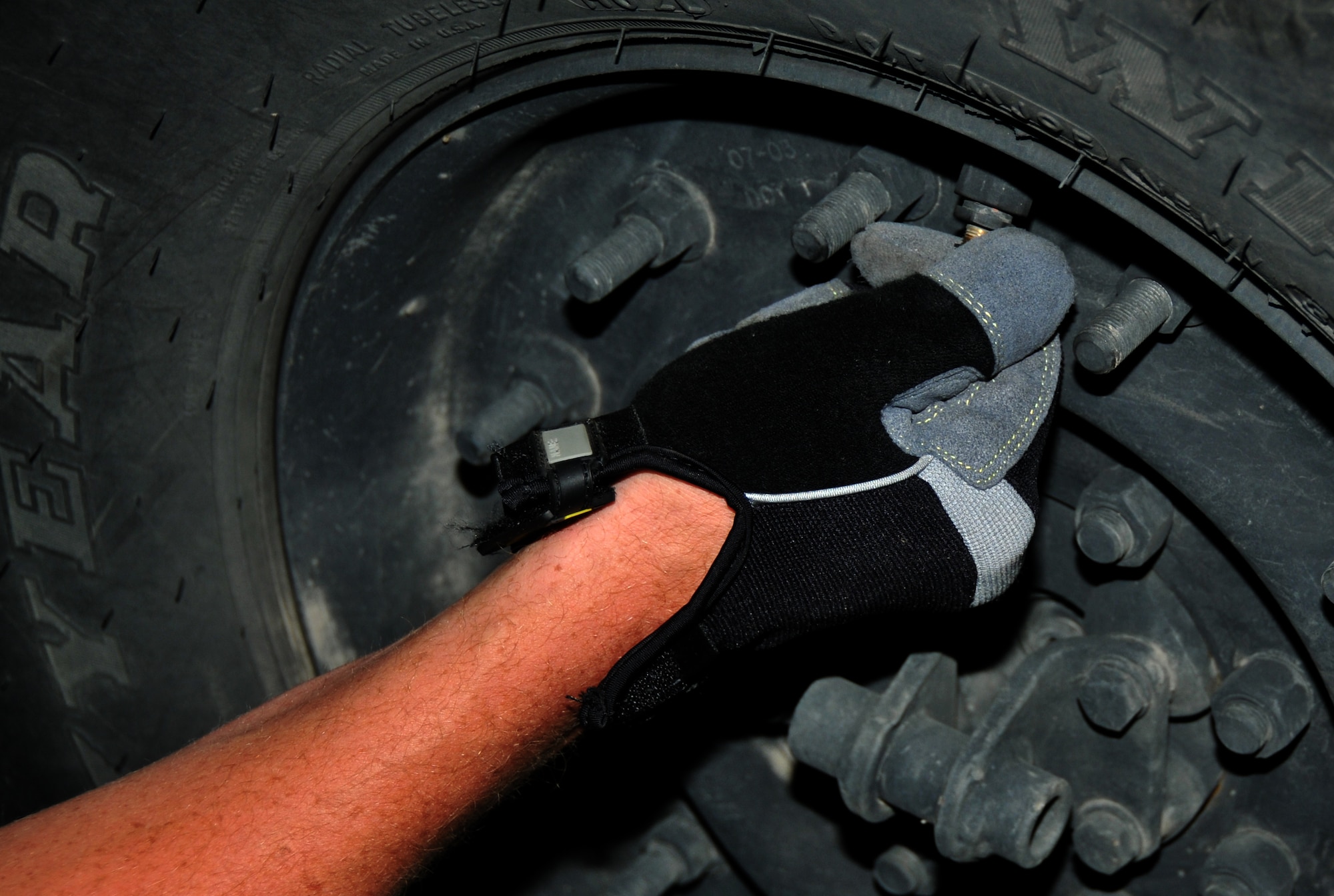 An Airman removes a cap to check the tire pressure of a Humvee, July 27, 2011 at Joint Base Lewis-McChord, Wash., during a joint inspection competition. The event was part of Air Mobility Rodeo 2011, a biennial international competition that focuses on mission readiness, featuring airdrops, aerial refueling and other events that showcase the skills of mobility crews from around the world. (U.S. Air Force photo/Airman 1st Class Jared Trimarchi) 
