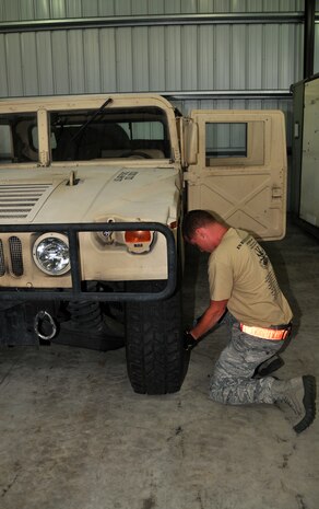 An Airman checks the air pressure of a Humvee tire, July 27, 2011 at Joint Base Lewis-McChord, Wash., during a joint inspection competition. The event was part of Air Mobility Rodeo 2011, a biennial international competition that focuses on mission readiness, featuring airdrops, aerial refueling and other events that showcase the skills of mobility crews from around the world. (U.S. Air Force photo/Airman 1st Class Jared Trimarchi) 
