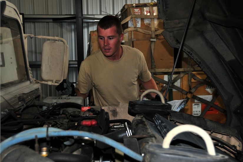 An Airman inspects the engine compartment of a Humvee, July 27, 2011 at Joint Base Lewis-McChord, Wash., during a joint inspection competition. The event was part of Air Mobility Rodeo 2011, a biennial international competition that focuses on mission readiness, featuring airdrops, aerial refueling and other events that showcase the skills of mobility crews from around the world. (U.S. Air Force photo/Airman 1st Class Jared Trimarchi) 
