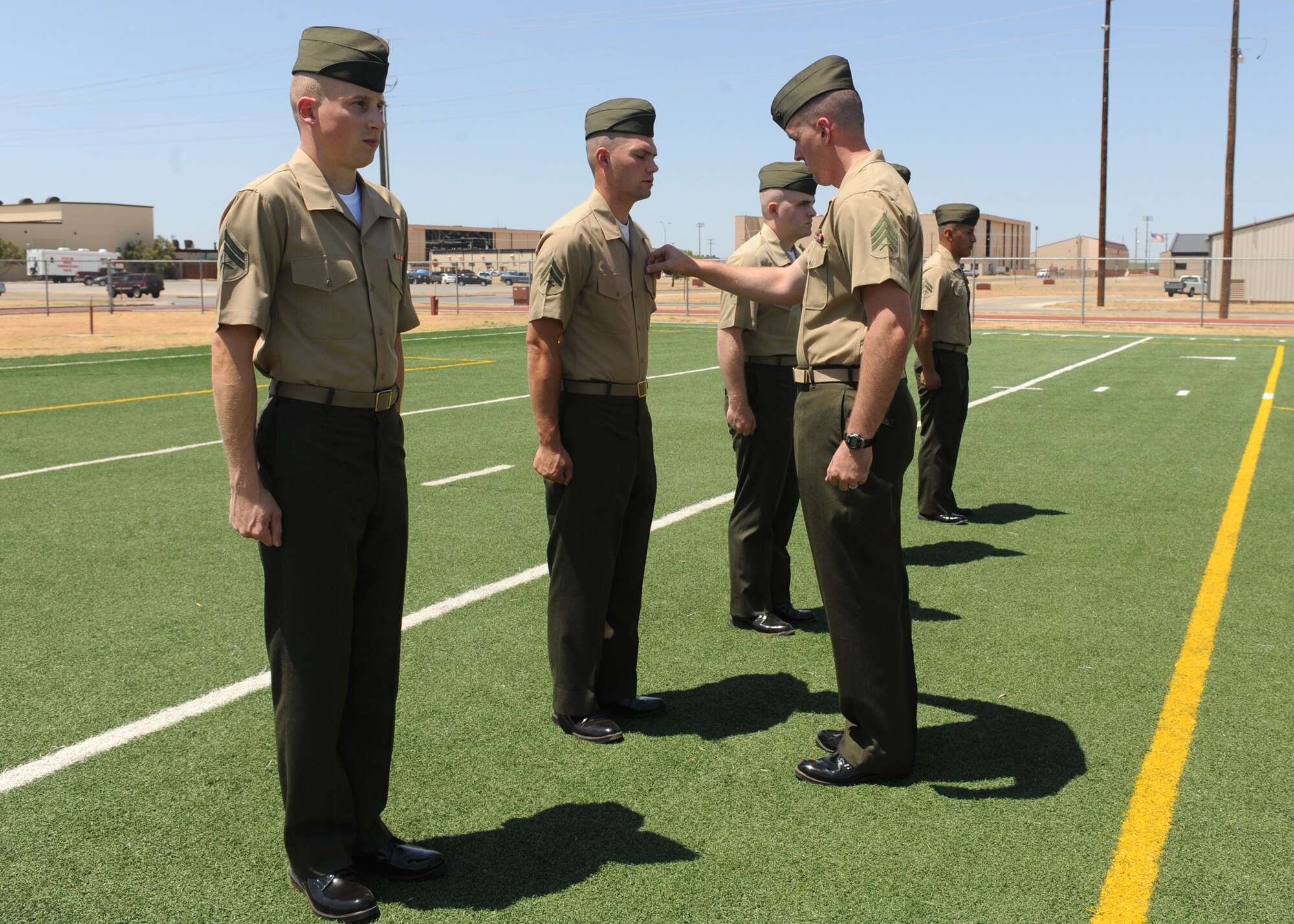 DYESS AIR FORCE BASE, Texas -- Marine Sgt. Brian Littlejohn, Corporal Course instructor, right, inspects Marine corporals attending the Corporals Course July 27, 2011. The Marine’s Enlisted Professional Military Education course is a 16-day course held once a year at Dyess. The course teaches Marine noncommissioned officers (corporals) how to lead in today’s Marine Corps. (U.S. Air Force photo by Airman 1st Class Jenifer H. Calhoun/Released)