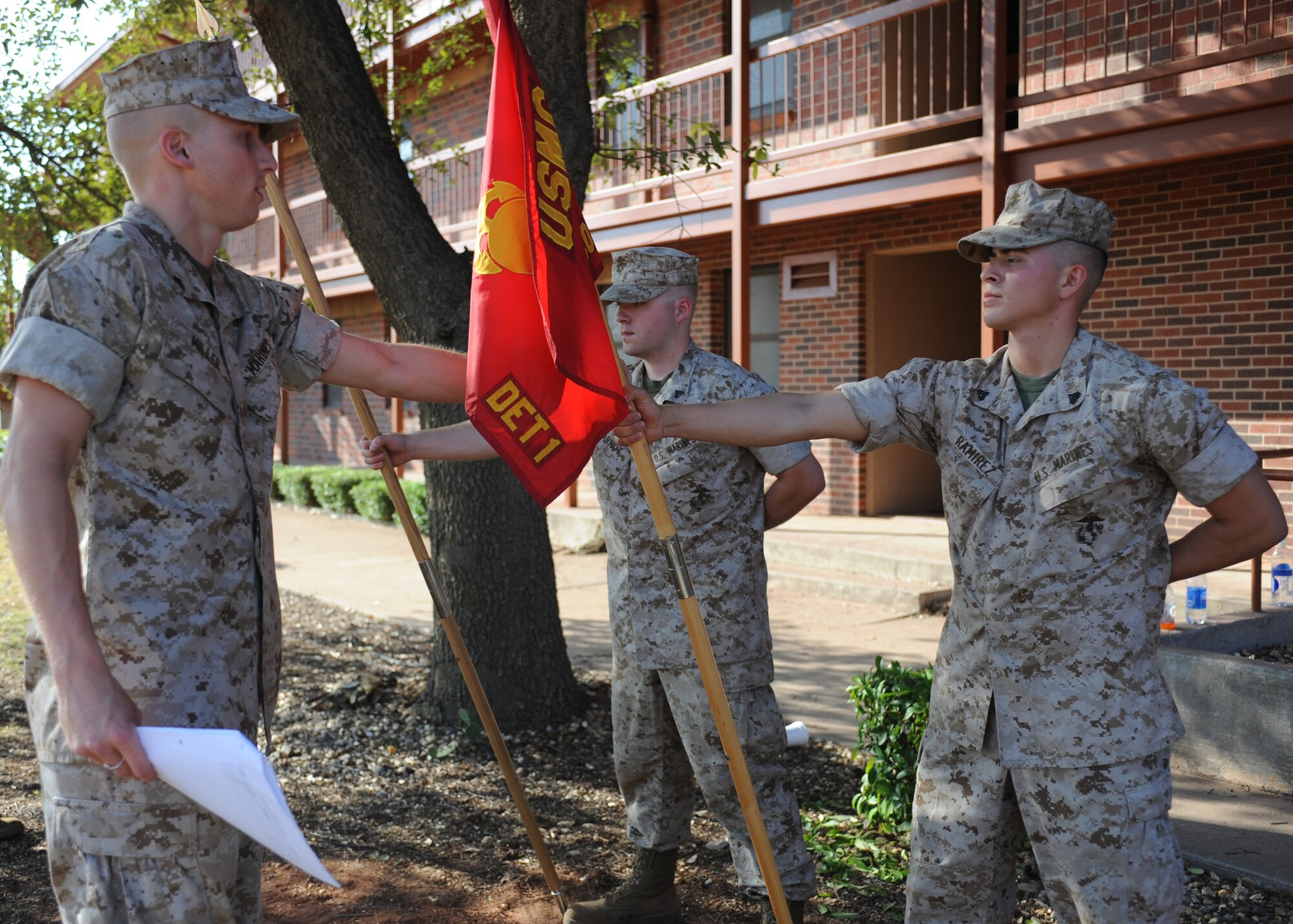 DYESS AIR FORCE BASE, Texas -- Marine Cpls. Christopher Miller, Corporals Course student, left, straightens the guidon of David Ramirez, Corporals Course student, at the Corporals Course July 27, 2011. The Marine’s Enlisted Professional Military Education course is a 16-day course held once a year at Dyess. The course teaches Marine noncommissioned officers (corporals) how to lead in today’s Marine Corps. (U.S. Air Force photo by Airman 1st Class Jenifer H. Calhoun/Released)
