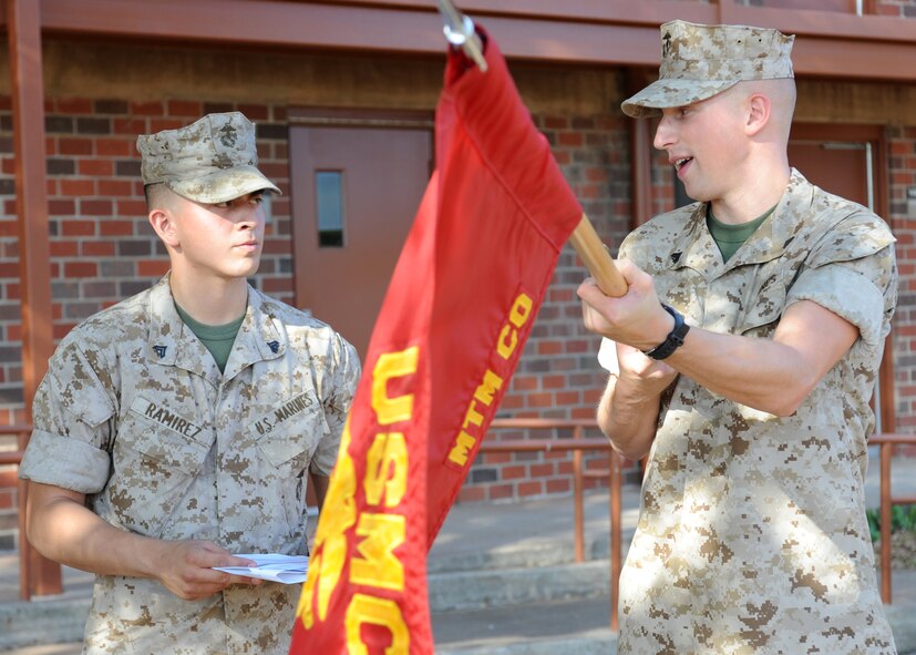 DYESS AIR FORCE BASE, Texas -- Marine Cpl. Christopher Miller, Corporals Course student, right, assists Cpl. David Ramirez, left, practice guidon procedures during the Corporals Course July 27, 2011. The Marine’s Enlisted Professional Military Education course is a 16-day course held once a year at Dyess. The course teaches Marine noncommissioned officers (corporals) how to lead in today’s Marine Corps. (U.S. Air Force photo by Airman 1st Class Jenifer H. Calhoun/Released)