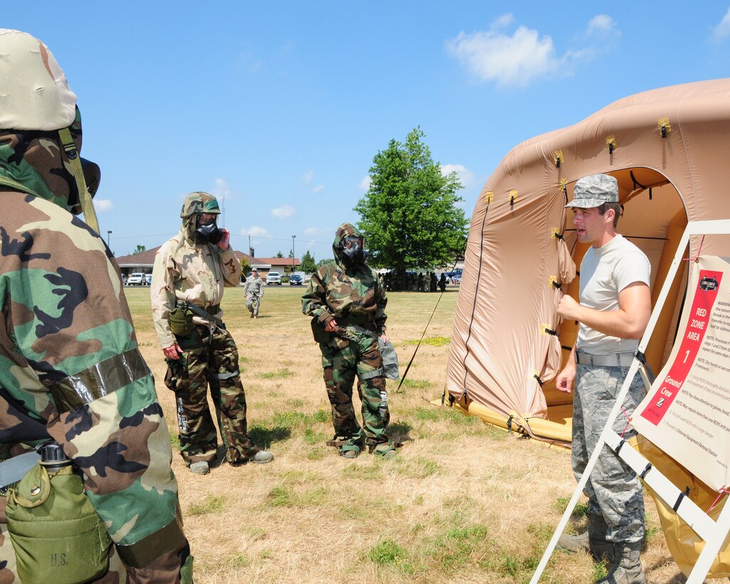914th Airlift Wing unit members receive information from a training instructor before they enter their next decontamination station Training on chemical, biological, radiological, nuclear, and explosive training was held during the July unit training assembly at the Niagara Falls Air Reserve Station on July 25th, 2011. The training is in preparation for the upcoming operational readiness inspection scheduled for July of 2012. (U.S. Air Force photo by Peter Borys)