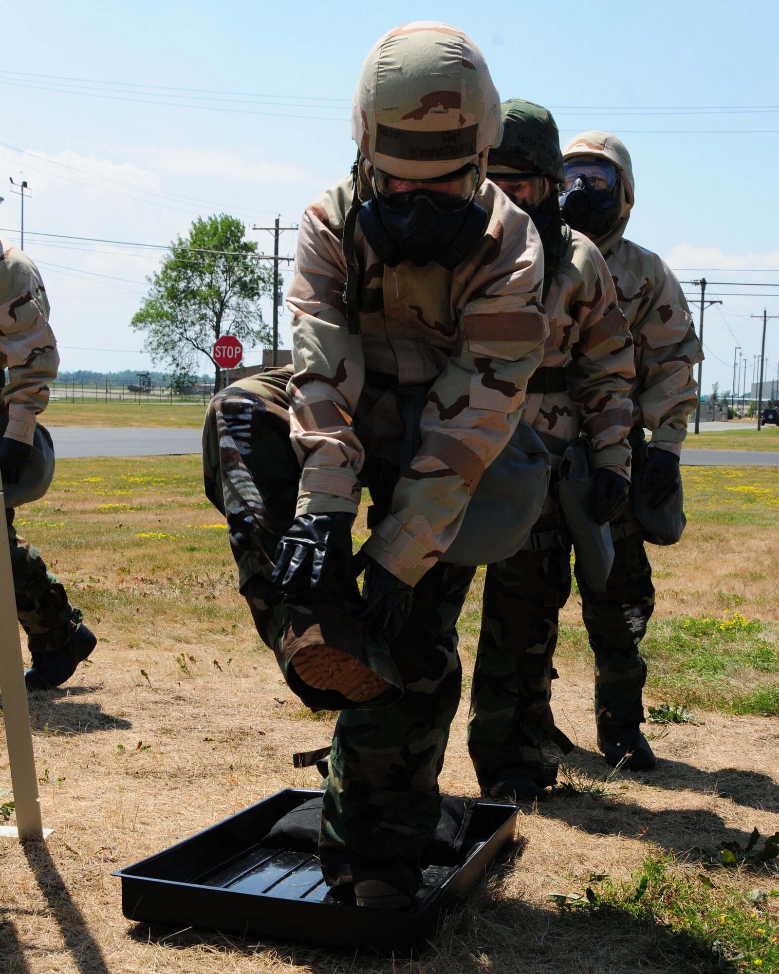 A 914th Airlift Wing unit member simulates washing off his boots from hazardous chemical exposure. Members received training on chemical, biological, radiological, nuclear and explosive training during the July unit training assembly at the Niagara Falls Air Reserve Station on July 25th, 2011. The training is in preparation for the upcoming operational readiness inspection scheduled for July of 2012. (U.S. Air Force photo by Peter Borys)
