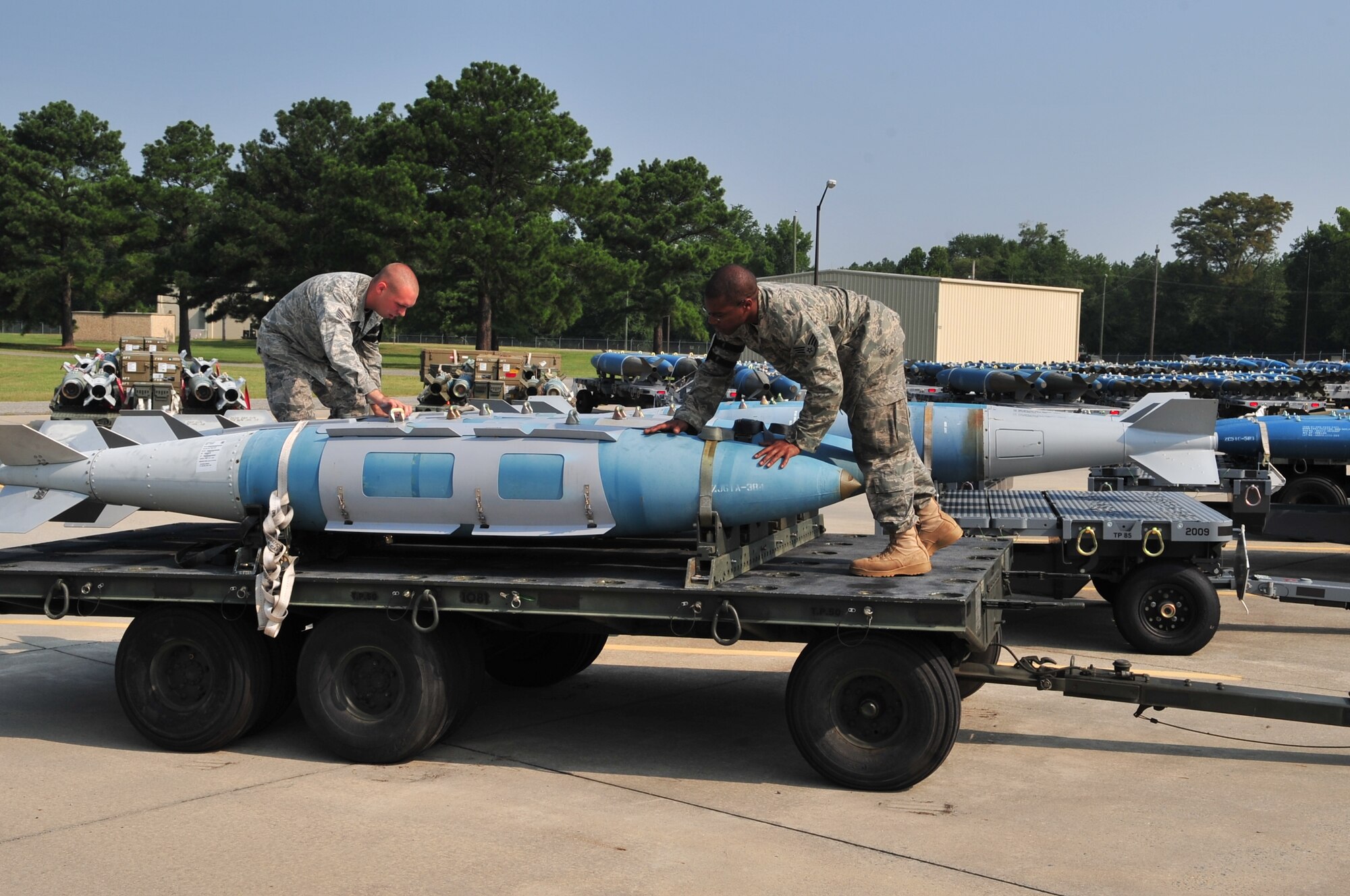 SEYMOUR JOHNSON AIR FORCE BASE, N.C. – Staff Sgt. Patric Senchuk and Senior Airman Kenneth Washington, both munitions systems specialists from the 4th Equipment Maintenance Squadron conventional maintenance flight, check panels on training bombs July 22, 2011. Airmen at the conventional maintenance flight construct and distribute several types of ammunition to many essential sources on base, including aircraft maintenance squadrons, explosive ordnance disposal and security forces. Senchuk is from Alpena, Mich., and Washington is from Tampa, Fla. (U.S. Air Force photo by Senior Airman Marissa Tucker/RELEASED)