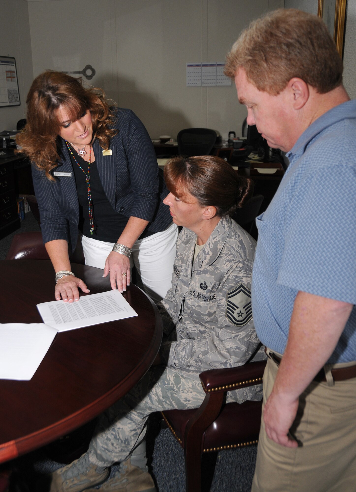 From left, Angela Wood, Forest City resident services management, explains the lease agreement to Senior Master Sgt. Julia Benavidez, 81st Force Support Squadron, as Brett Long, Keesler’s housing flight chief, looks on. Benavidez’s husband, Senior Master Sgt. Juan Benavidez, 81st Logistics Readiness Squadron, is currently deployed to Kyrgyzstan.  A lease-signing event is 7:30 a.m. to 8 p.m. at the Bay Breeze Event Center.  (U.S. Air Force photo by Kemberly Groue)