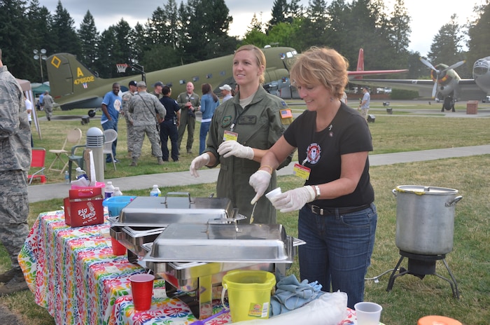 Capt. Keri Fleming and Ms. Karen Elsey from Team Charleston serve shrimp and grits to Airmen and spectators at Ranier Ranch atn Joint Base Lewis-McCHord July 26 during the Air Mobility Command 2011 Rodeo. (U.S. Air Force photo/2nd Lt. Susan Carlson) 