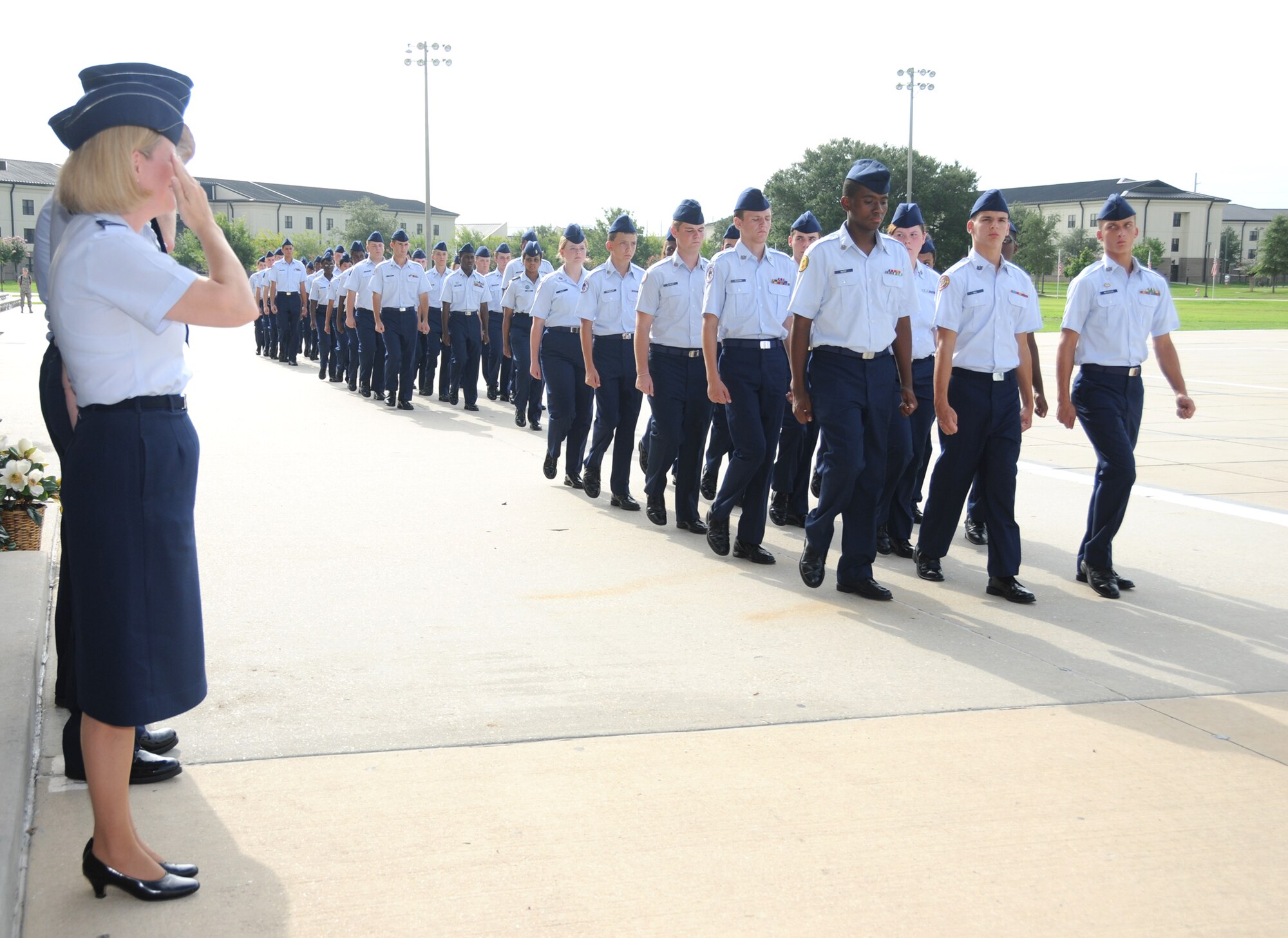 Col. Lynn Connett, left, 81st Training Group commander, salutes Junior ROTC cadets during a pass in review parade July 21 on the parade field that ended a week-long encampment hosted annually by Biloxi High School’s Junior ROTC program. The event trained about 140 cadets from 19 high schools in a six-state area in leadership skills.  (U.S. Air Force photo by Kemberly Groue)