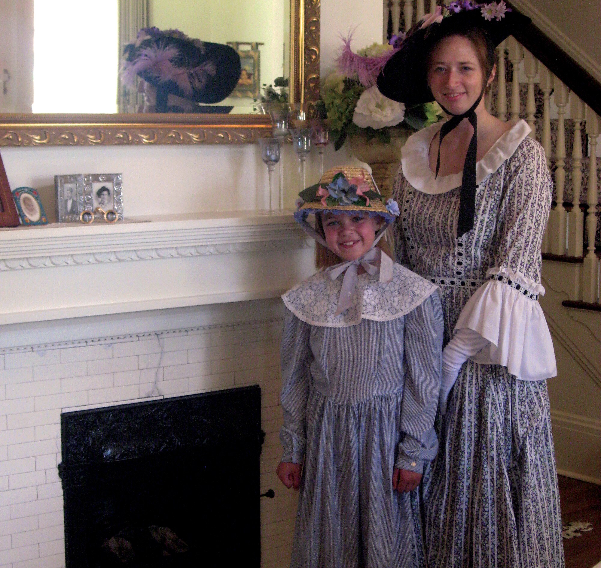 Staff Sgt. Erin Millbaugh, 90th Missile Wing protocol specialist, and Madeline, age 9, daughter of Lt. Col. Matthew Dillow, 321st Missile Squadron commander, dress up and show off the home of Maj. Gen. C. Donald Alston, 20th Air Force commander, during the Historic Homes Tour July 24. (U.S. Air Force photo by Blaze Lipowski)