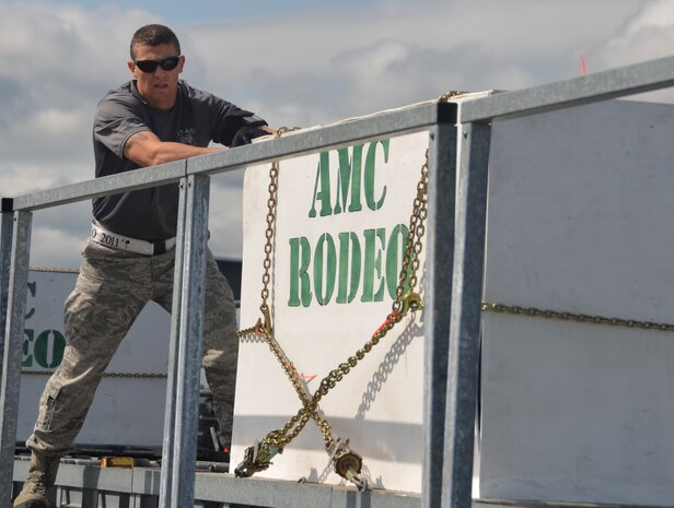 Staff Sgt. Matt Lumm from Team Charleston's Rodeo team pushes a simulated cargo pallet from the K-loader onto the highline dock during the 25K loader obstacle course at the Air Mobility Command Rodeo 2011 at Joint Base Lewis-McChord, Wash., July 27. (U.S. Air Force photo/2nd Lt. Susan Carlson)