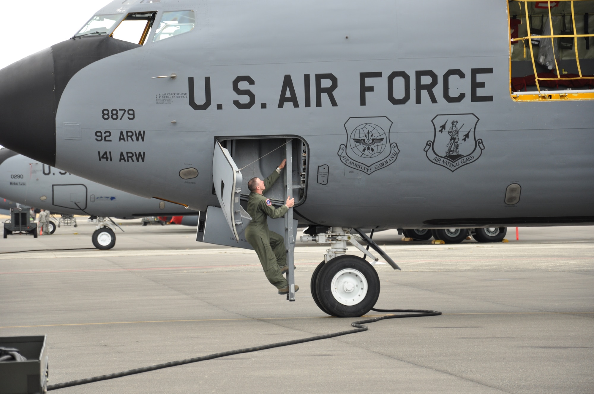 After sprinting from the K loaders, Tech. Sgt. David Nixon climbs back aboard the KC-135 July 26 during Fairchild’s turn at the KC-135 load competition. The event was part of the Air Mobility Rodeo at Joint Base Lewis-McChord. (U.S. Air Force Photo/Tech. Sgt. Jennifer Buzanowski)