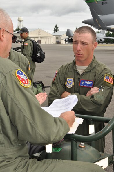 Tech. Sgt. David Nixon discusses the event rules with Senior Master Sgt. Mike Morris during the event pre-brief during Fairchild’s turn at the KC-135 load competition. The event was part of the Air Mobility Rodeo at Joint Base Lewis-McChord.  (U.S. Air Force Photo/Tech. Sgt. Jennifer Buzanowski)