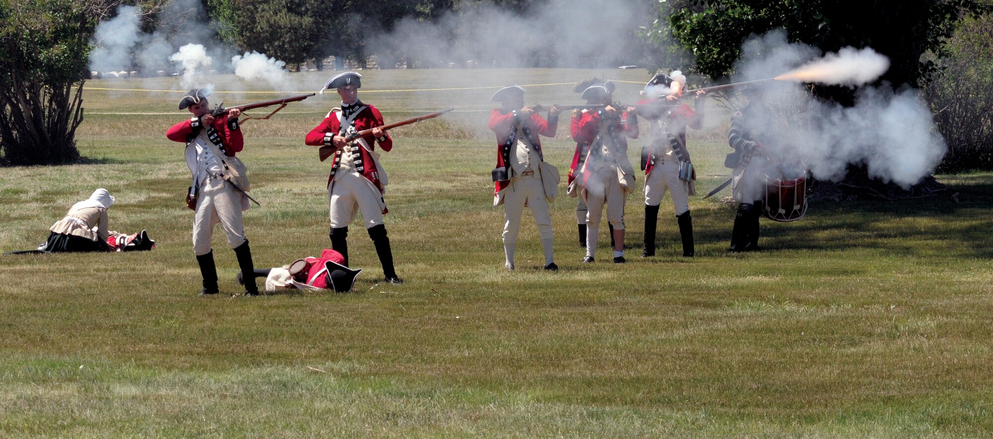 British re-enactors fire their muskets towards the American colonialists during a reenactment July 23.. (U.S. Air Force photo by Blaze Lipowski)