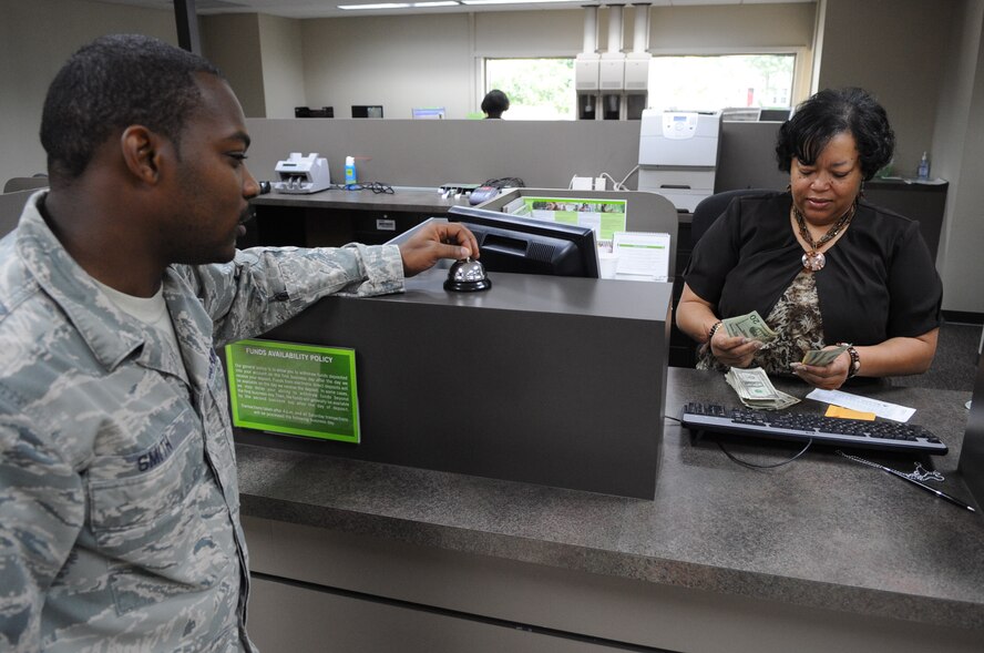 Staff Sgt. Jermain Smith, 2nd Bomb Wing chaplain assistant, deposits chapel funds while Ella Francis, bank teller, counts money at a bank in Shreveport, La., July 19. The funds provide resources for retreats, family programs, fellowships and the River's Edge, a program designed for Barksdale's Airmen. (U.S. Air Force photo/Airman 1st Class Micaiah Anthony)(RELEASED)