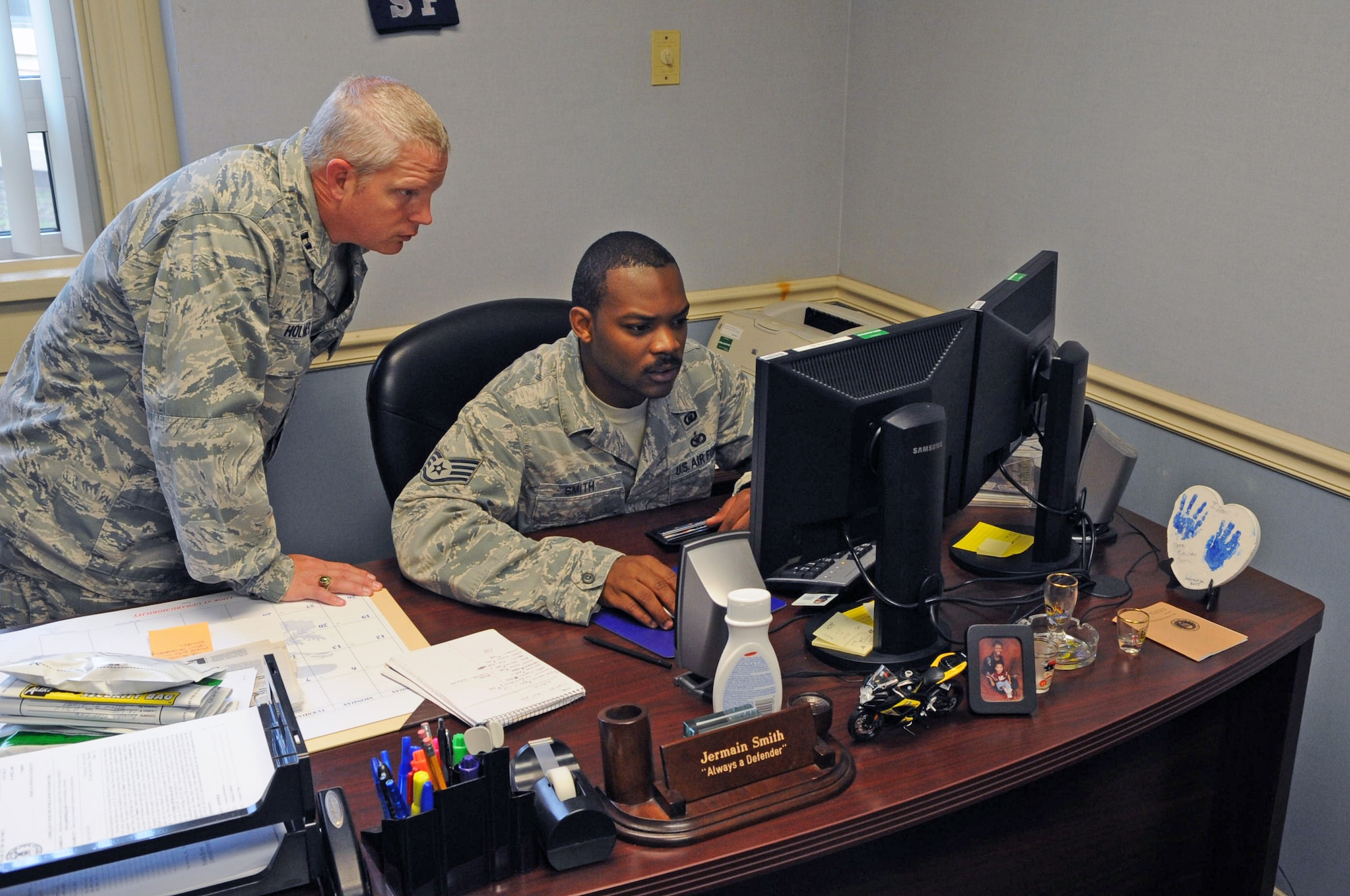 Capt. Richard Holmes, 2nd Maintenance Group and 2nd Operations Group chaplain, and Staff Sgt. Jermain Smith, 2nd Bomb Wing chaplain assistant, check events planned for the day in the main chapel on Barksdale Air Force Base, La., July 19. Smith's morning consists of performing administrative duties such as managing contracts, meeting contractors and purchasing office supplies. (U.S. Air Force photo/Airman 1st Class Micaiah Anthony)(RELEASED)
