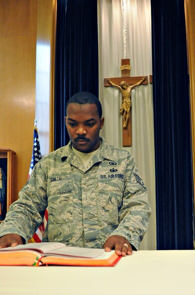 Staff Sgt. Jermain Smith, 2nd Bomb Wing chaplain assistant, sets up Chapel 2 for daily mass on Barksdale Air Force Base, La., July 19.  Chapel 2 provides daily mass at 11:30 a.m. every Monday through Thursday. (U.S. Air Force photo/Airman 1st Class Micaiah Anthony)(RELEASED)