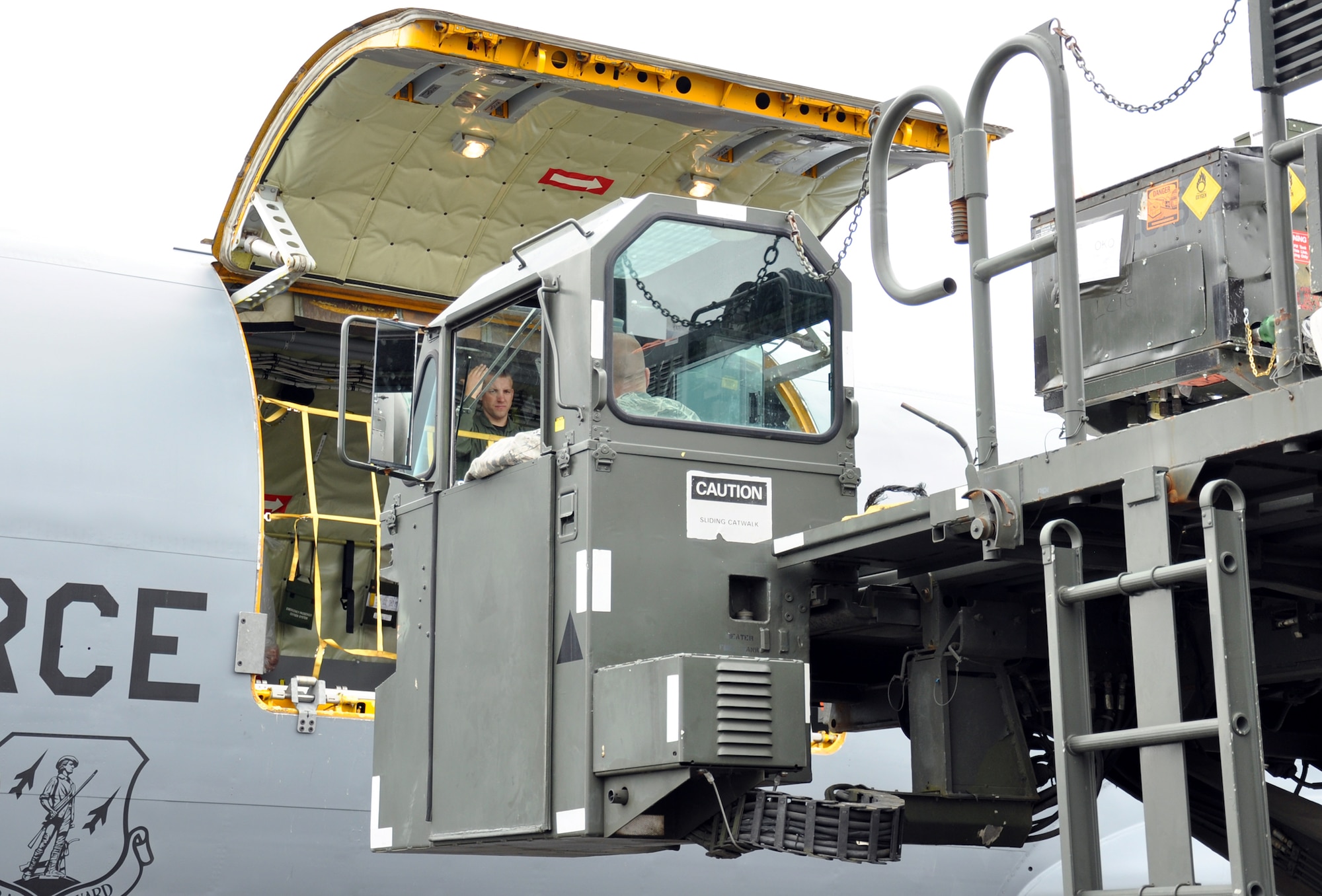 Staff Sgt. Chad Holloway directs the K loader driver as he nears the loading platform of the KC-135 July 26 during Fairchild’s turn at the KC-135 load competition. The event was part of the Air Mobility Rodeo at Joint Base Lewis-McChord. (U.S. Air Force Photo/Tech. Sgt. Jennifer Buzanowski)
