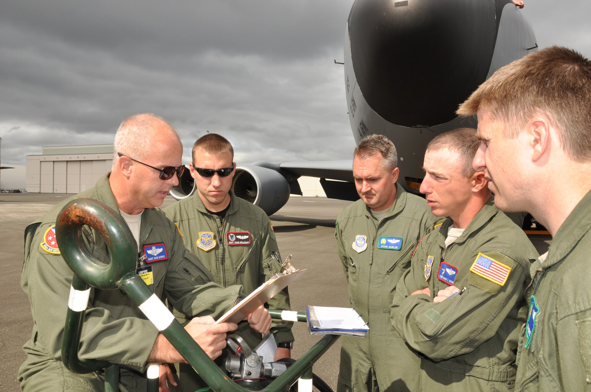 Senior Master Sgt. Mike Morris briefs the Fairchild KC-135 crew for the load competition as part of the Air Mobility Rodeo July 26 at Joint Base Lewis-McChord. From left, Staff Sgt. Chad Holloway, Maj. Steve Harler, Tech. Sgt. David Nixon and Capt. Jim Blech. The team completed the challenge to load cargo and passengers in 73 minutes to come in under the time limit of 90 minutes. (U.S. Air Force Photo/Tech. Sgt. Jennifer Buzanowski)