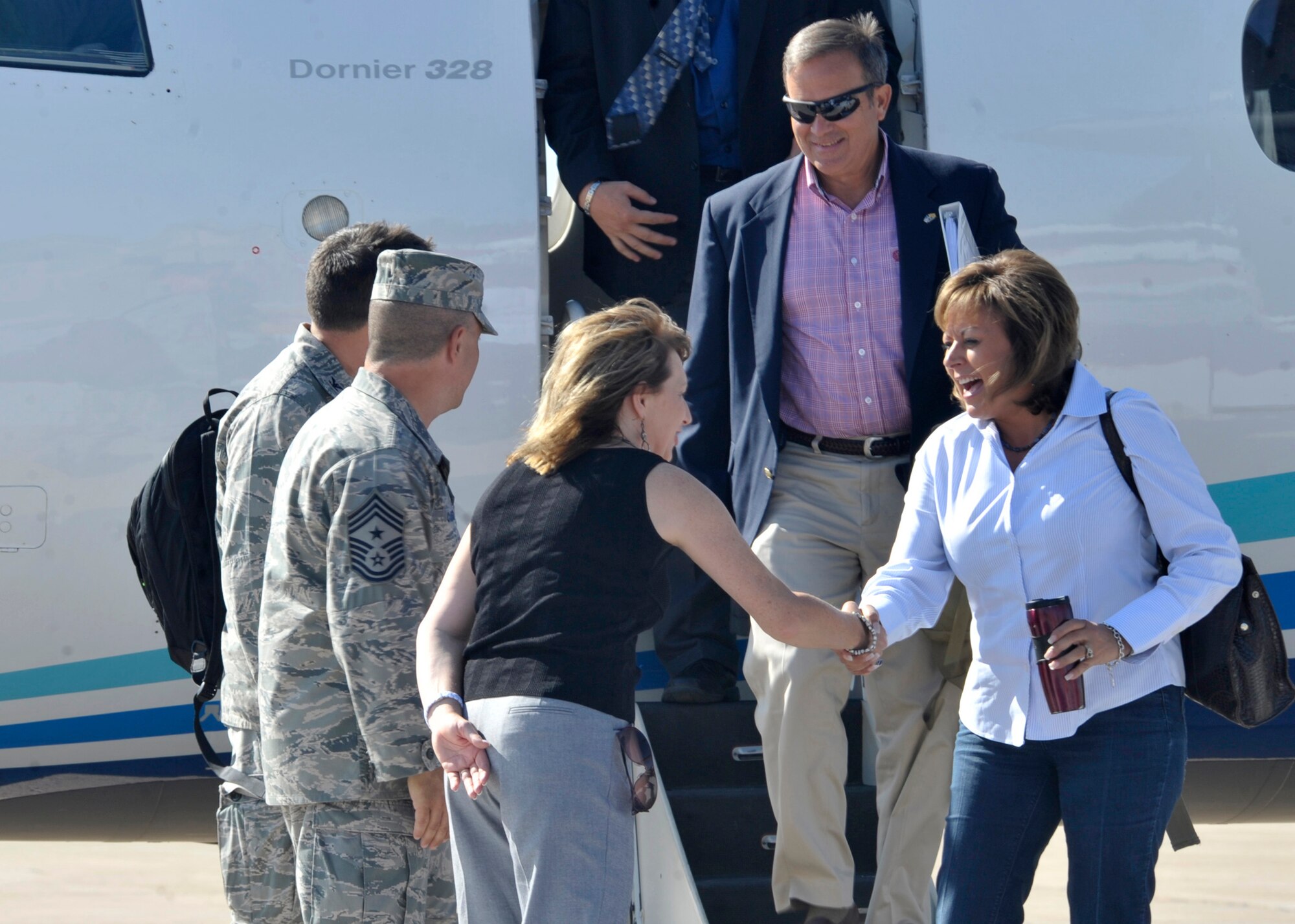 U.S. Air Force Chief Master Sgt. Matthew Caruso, 27th Special Operations Wing command chief and Sheila Glover, 27th Special Operations Wing chief of protocol, welcome New Mexico Gov. Susana Martinez to Cannon Air Force Base, July 27, 2011, for a base tour.  The trip was the governor's first official visit to a New Mexico Air Force Base since taking office in January 2011. (U.S. Air Force photo by Airman Ericka Engblom)