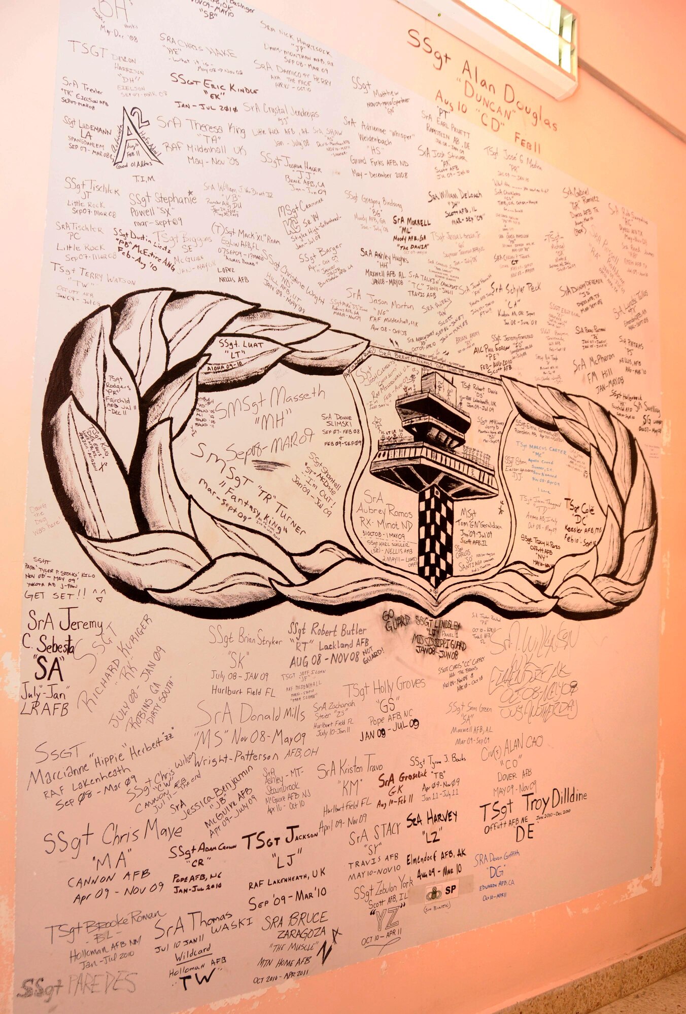 The wall pictured has been in the 332nd Expeditionary Operations Support Squadron Air Traffic Control tower at Joint Base Balad, Iraq, since 2004 and has been signed by every controller. The wall will be painted over as the tower is prepared to be transitioned over to the Iraqi Air Force. (U.S. Air Force photo by Senior Airman Jeffrey Schultze)
