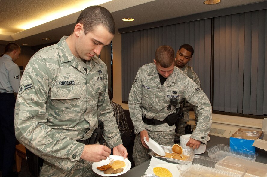 HANSCOM AIR FORCE BASE, Mass. – Airman 1st Class Michael Crocker and Airman 1st Class Scott Preston, both from the 66th Security Forces Squadron, load up on pancakes, sausage, eggs and more during the dorm dinner July 25. The Patriot Enlisted Association hosted the dinner and, after receiving input from dorm residents, decided to serve breakfast food. (U.S. Air Force photo by Mark Herlihy)
