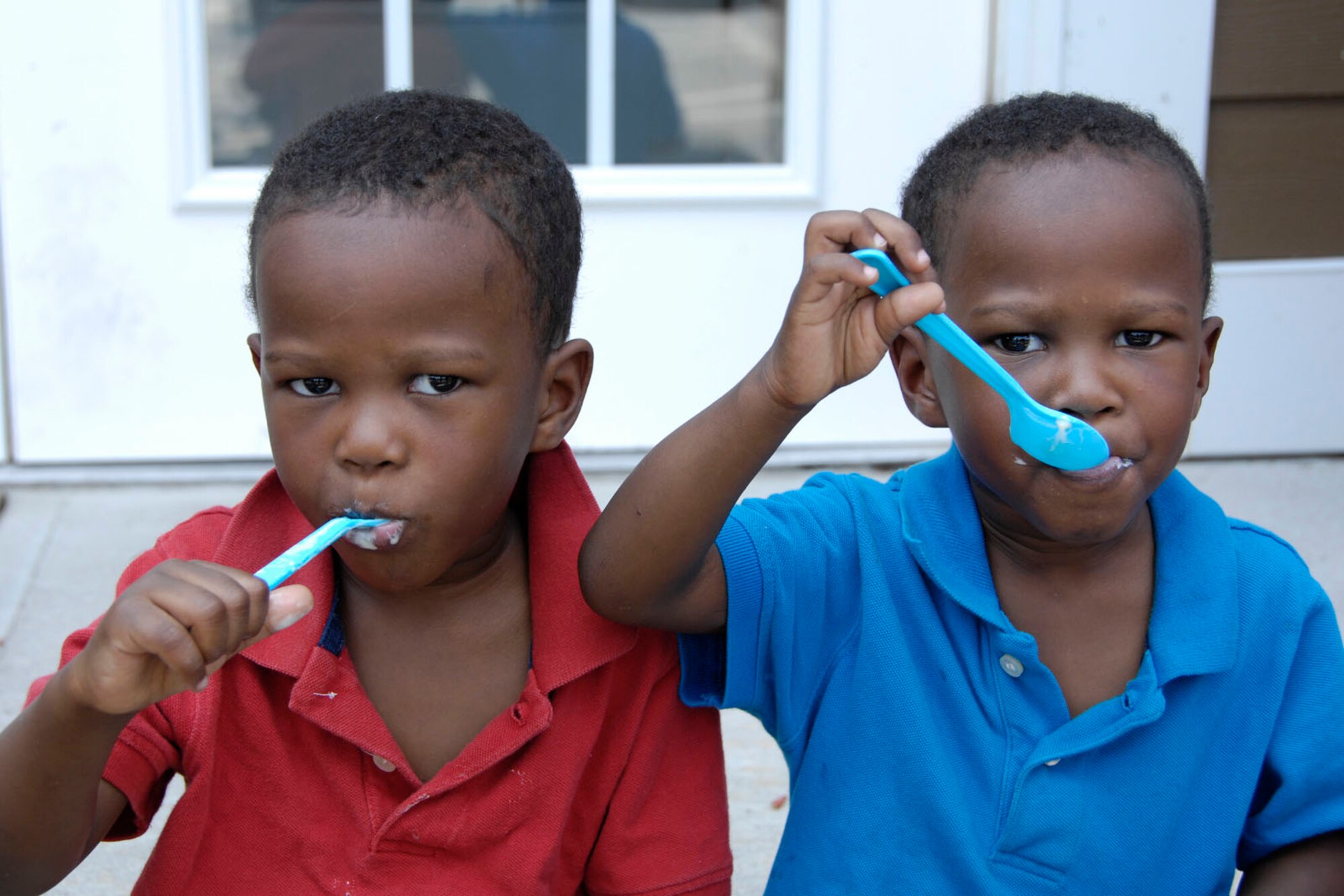 HANSCOM AIR FORCE BASE, Mass. - Dallas and Donovan Davis take a big bite of ice cream during The Landings at Hanscom’s ice cream social, held at the leasing office July 21. Housing residents could take advantage of cold ice cream on a hot day. (U.S. Air Force photo by Linda LaBonte Britt)