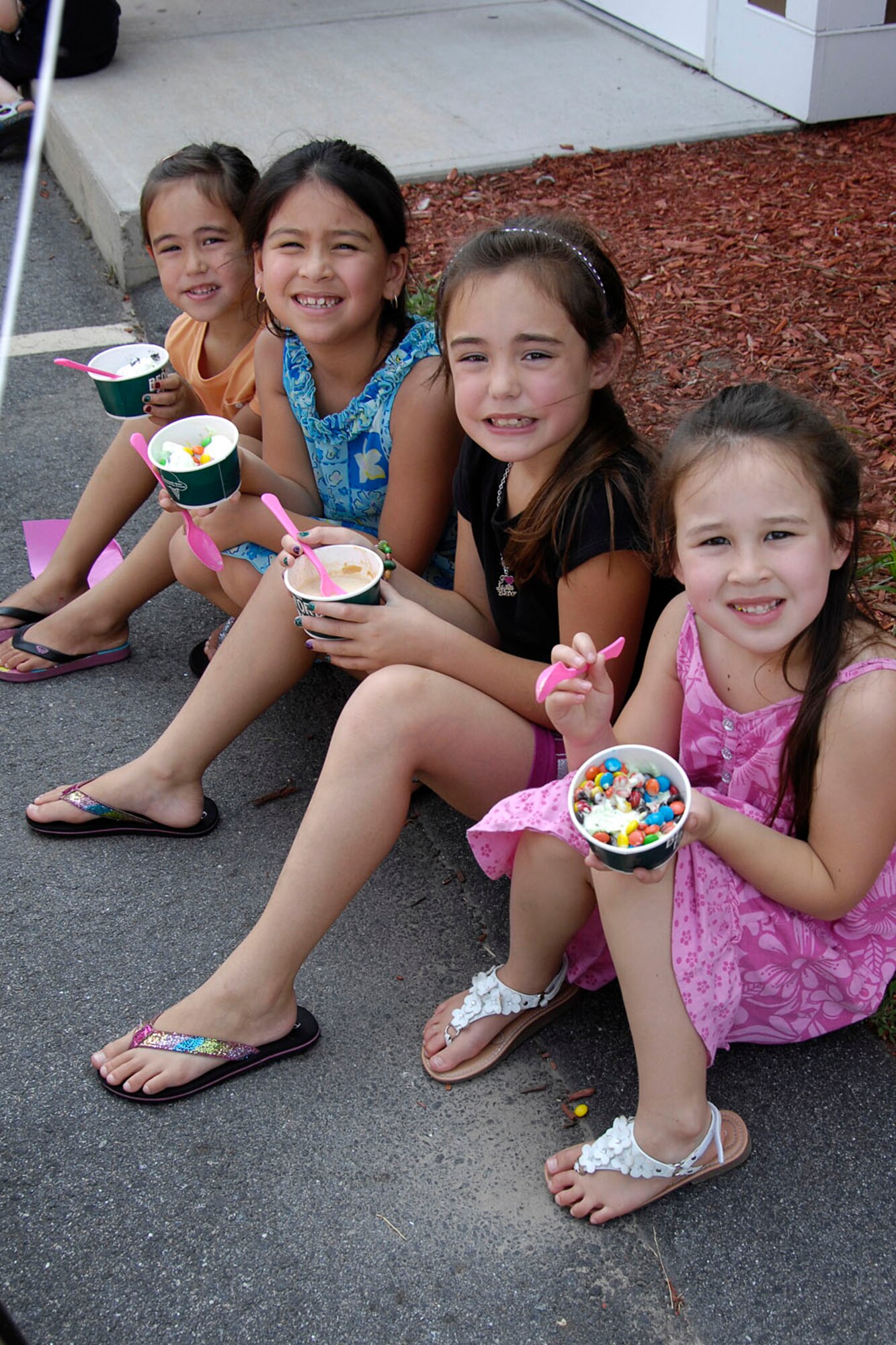 HANSCOM AIR FORCE BASE, Mass. – Madison Hagler, Leeanne Aulik, Kaylee Hagler and Faith Aulik (left to right) enjoy ice cream during The Landings at Hanscom ice cream social July 21 at the leasing office. Base residents were invited to enjoy a cold treat on a day temperatures reached above 90 degrees. (U.S. Air Force photo by Linda LaBonte Britt)