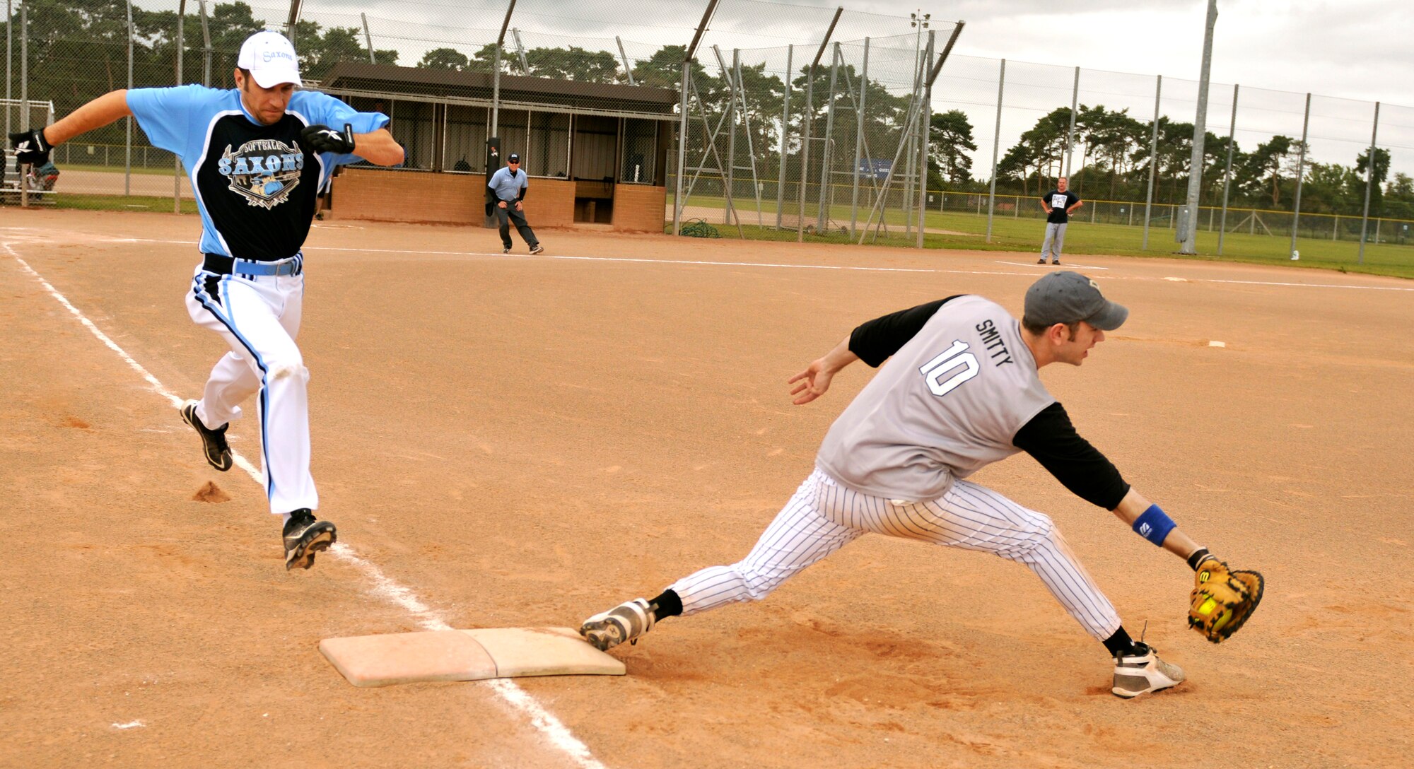 ROYAL AIR FORCE LAKENHEATH, England - Tech. Sgt. Daniel Knez, 48th Logistics Readiness Squadron fixed facility supervisor, runs to first base as Staff Sgt. Kyle Smith, 48th Security Forces Squadron United Kingdom Corrections Facility NCO in charge, catches the ball during the 2011 Base Intramural Softball playoffs, July 26, 2011. The 48th SFS defeated the 48th LRS with a score of 13-7. (U.S. Air Force photo/Senior Airman Tiffany M. Deuel)