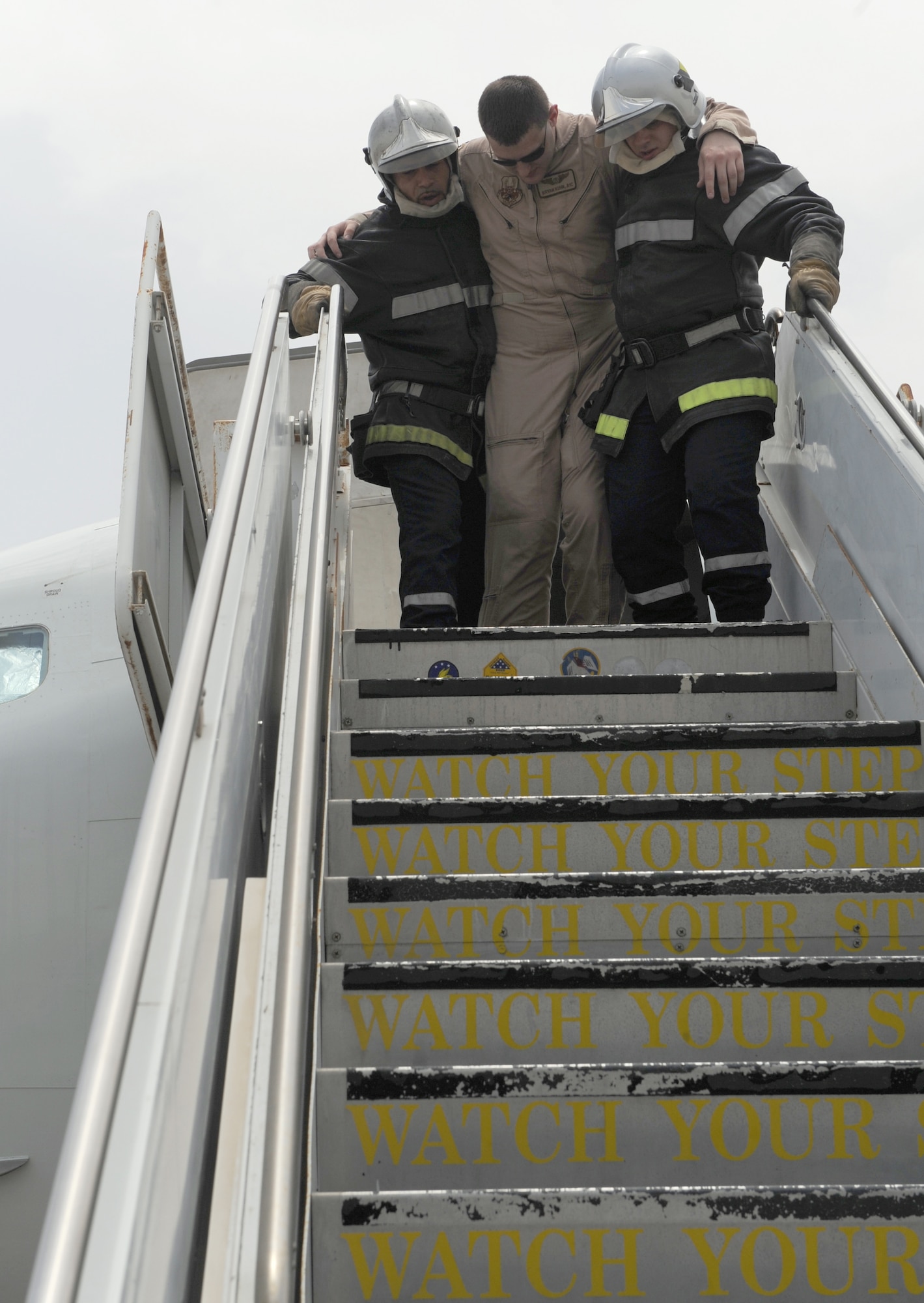 French air force firefighters remove casualties from an aircraft during a combined training scenario with the 380th Air Expeditionary Wing, July 26, 2011, in Southwest Asia. The exercise was used to assess the interoperablility of the U.S., French and host nation fire departments at the deployed location. The scenario simulated an auxiliary power unit, or APU, exploding causing a ground fire with nine casualties. (U.S. Air Force photo/Master Sgt. Chance Babin)