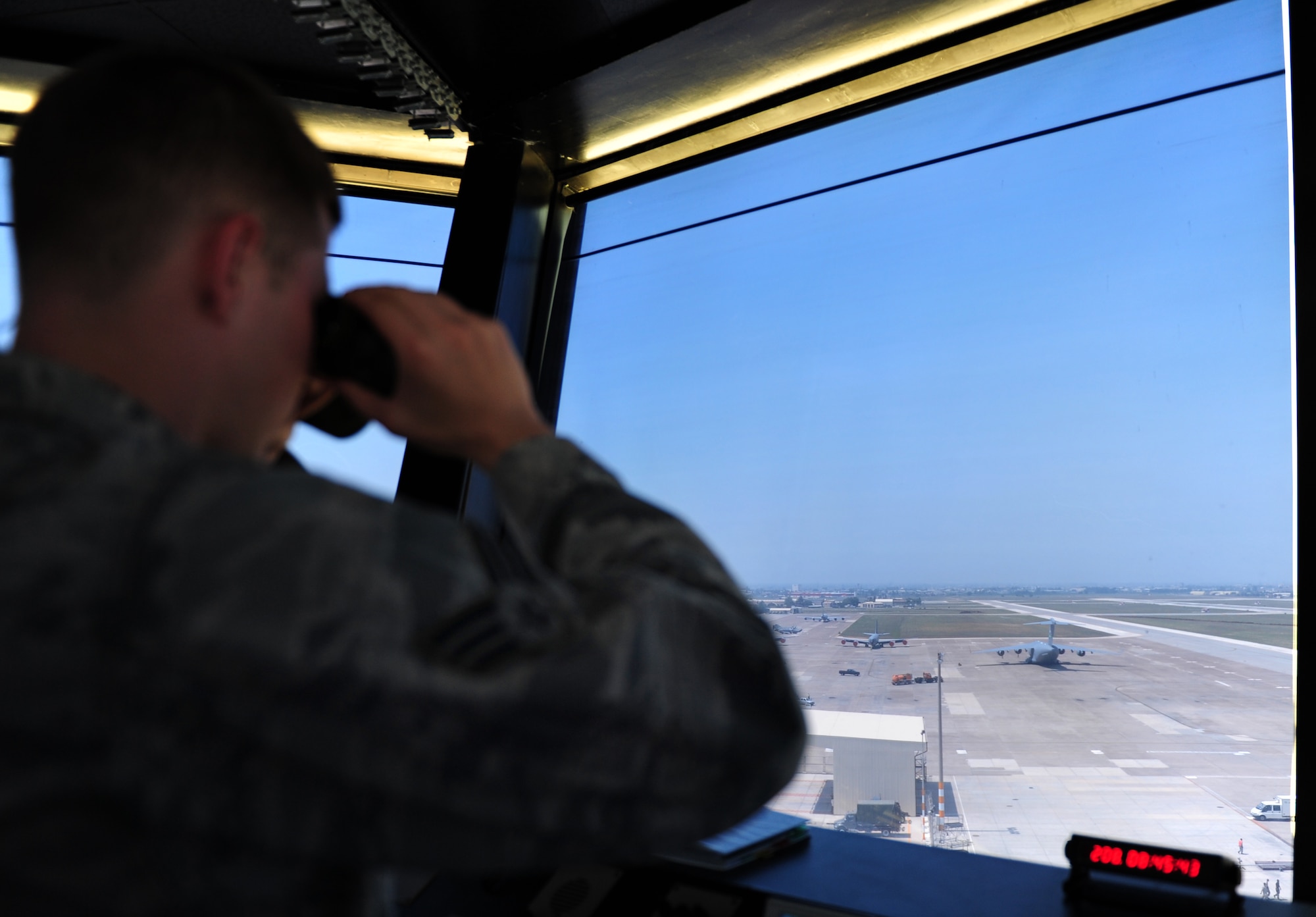 Senior Airman Matthew Thornton, 39th Operations Squadron air traffic control journeyman, watches a C-17 Globemaster III aircraft taxi before take off July 27, 2011, at Incirlik Air Base, Turkey. Air traffic controllers here run about 25,000 operations a year. (U.S. Air Force photo by Senior Airman Anthony Sanchelli/Released)