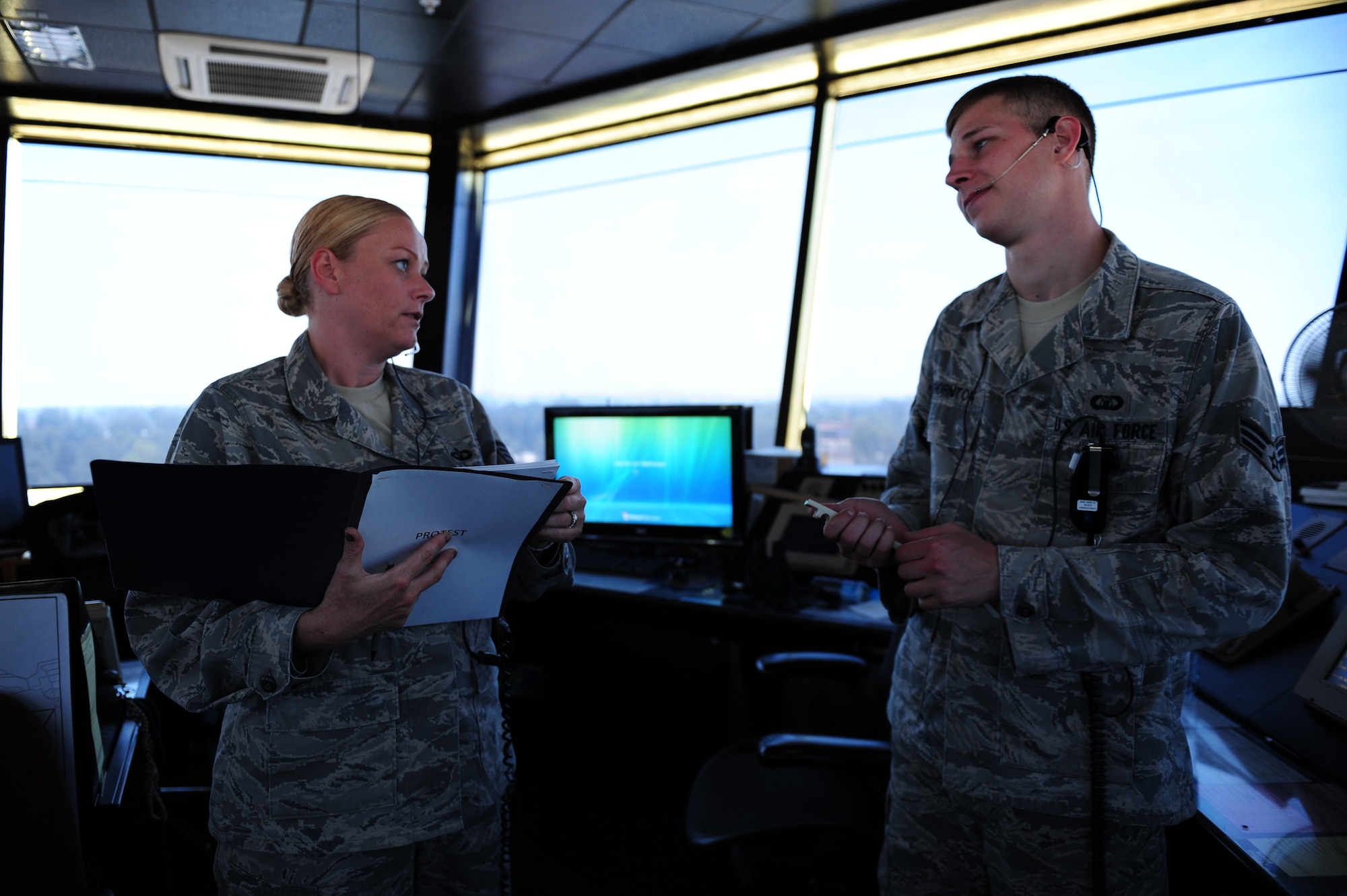 Tech. Sgt. Jennifer Rowles, 39th Operations Squadron tower watch supervisor, and Senior Airman Matthew Thornton, 39th OS air traffic control journeyman, discuss air traffic control procedures July 27, 2011, at Incirlik Air Base, Turkey. Air traffic controllers must take a monthly proficiency test to ensure they are knowledgeable about all rules and regulations. (U.S. Air Force photo by Senior Airman Anthony Sanchelli/Released)