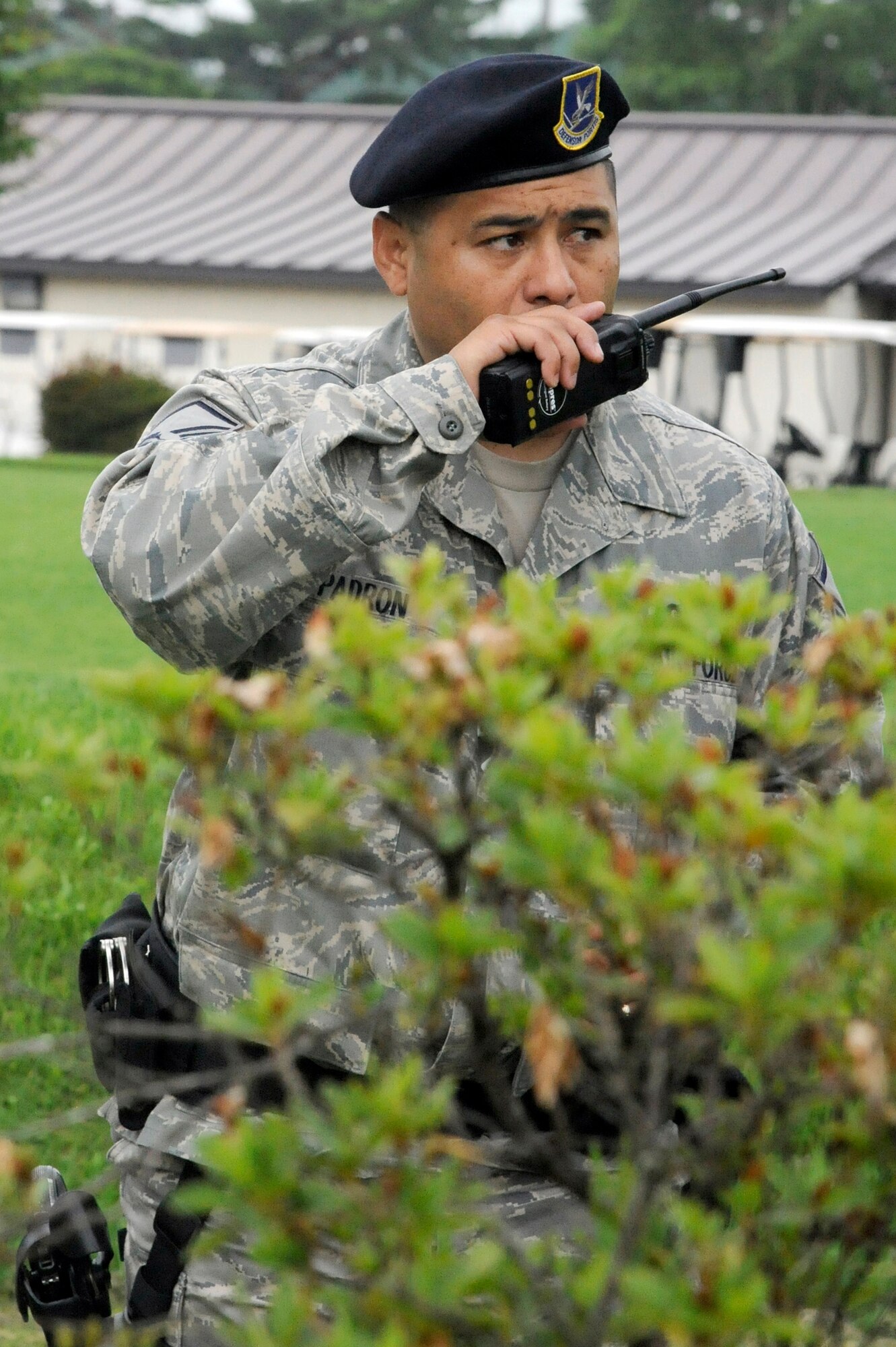 MISAWA AIR BASE, Japan -- Master Sgt. Christopher Padron, 35th Security Forces Squadron, calls SFS dispatch while pursuing a suspect during a robbery training exercise July 28. The exercise gave law enforcement Airmen an opportunity to practice maintaining security around the base. (U.S. Air Force photo/Staff Sgt. Marie Brown)