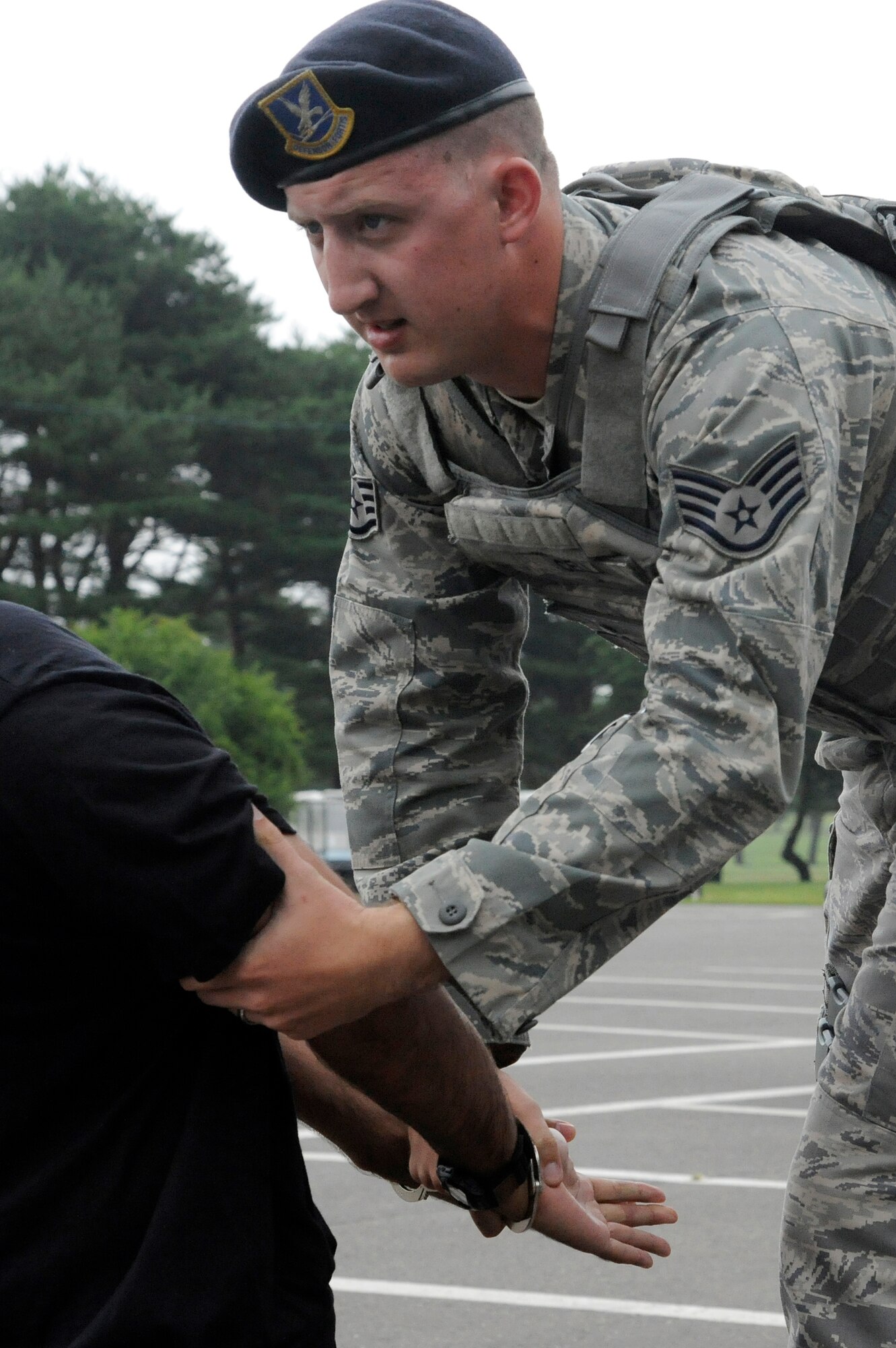 MISAWA AIR BASE, Japan -- Staff Sgt. Matthew Cella, 35th Security Forces Squadron, apprehends a suspect during a robbery training exercise scenario July 28. The exercise allowed Airmen to demonstrate their ability to regain control of a robbery scenario. (U.S. Air Force photo/Staff Sgt. Marie Brown)