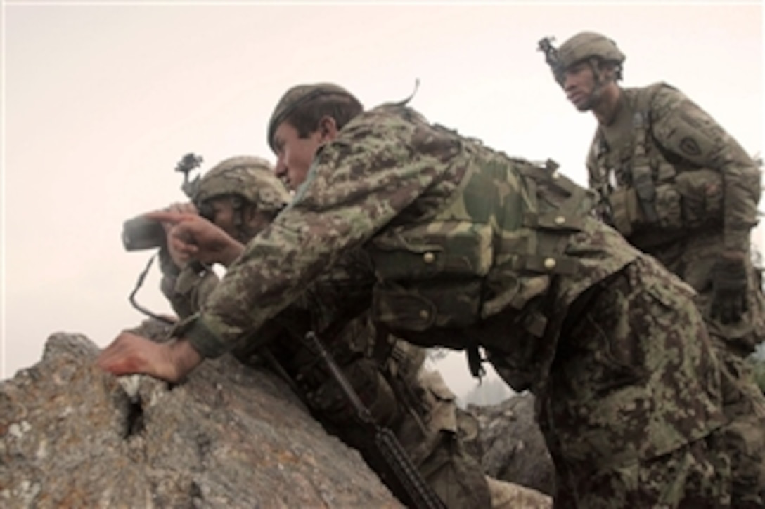 U.S. Army soldiers from Delta Company, 2nd Battalion, 35th Infantry Regiment and an Afghan National army soldier survey the valley below for insurgent activity during Operation Hammer Down II in the Watahpur district, Kunar province, Afghanistan, on June 26, 2011.  The operation is a coalition effort to disrupt insurgents operating and training throughout the Pech Valley.  