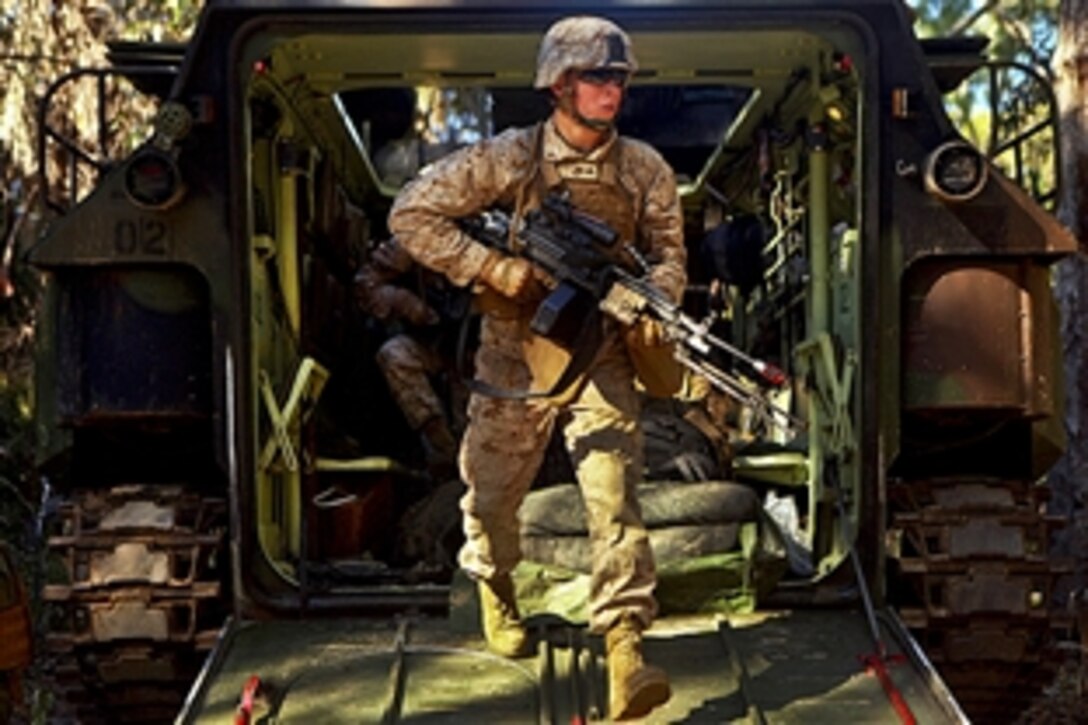 A U.S. Marine exits an amphibious assault vehicle during a mock mechanized assault during Talisman Sabre 2011 at Camp Rock, Australia, July 19, 2011. The exercise provides an opportunity for U.S. and Australian forces to conduct operations in a combined environment to increase bilateral war-fighting capabilities.