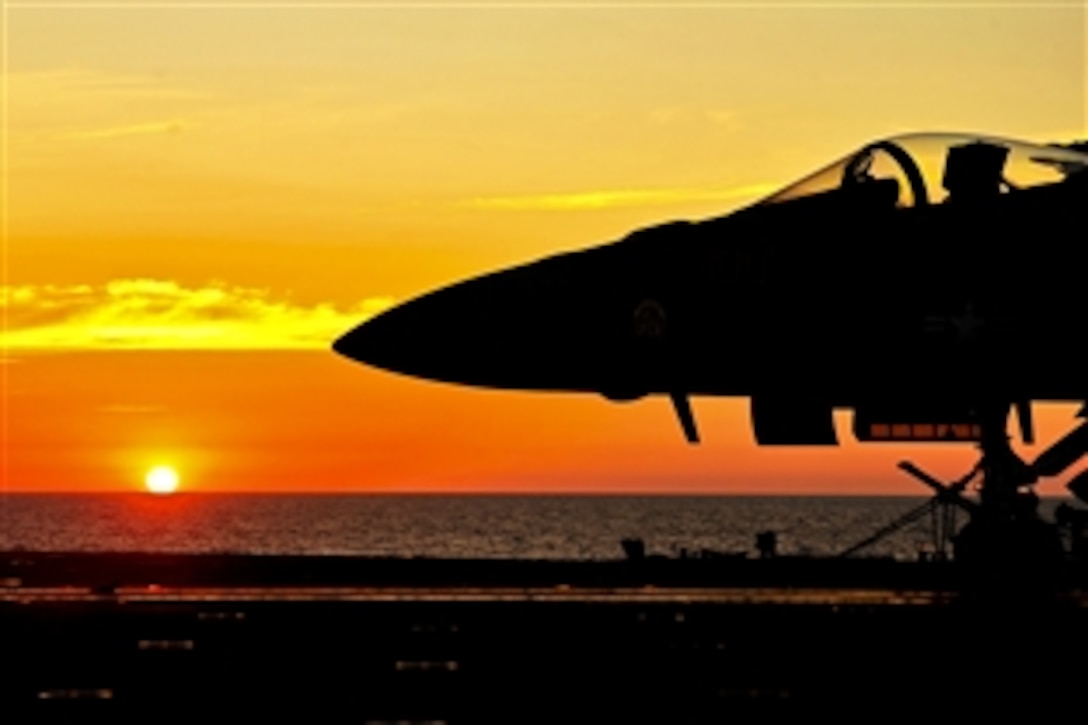 The sun rises over the flight deck on the nuclear aircraft carrier USS George Washington in the Indian Ocean, July 22, 2011. The USS George Washington is participating in Talisman Sabre 2011, a bilateral exercise to train Australian and U.S. forces in planning and conducting combined operations to improve combat readiness and interoperability.