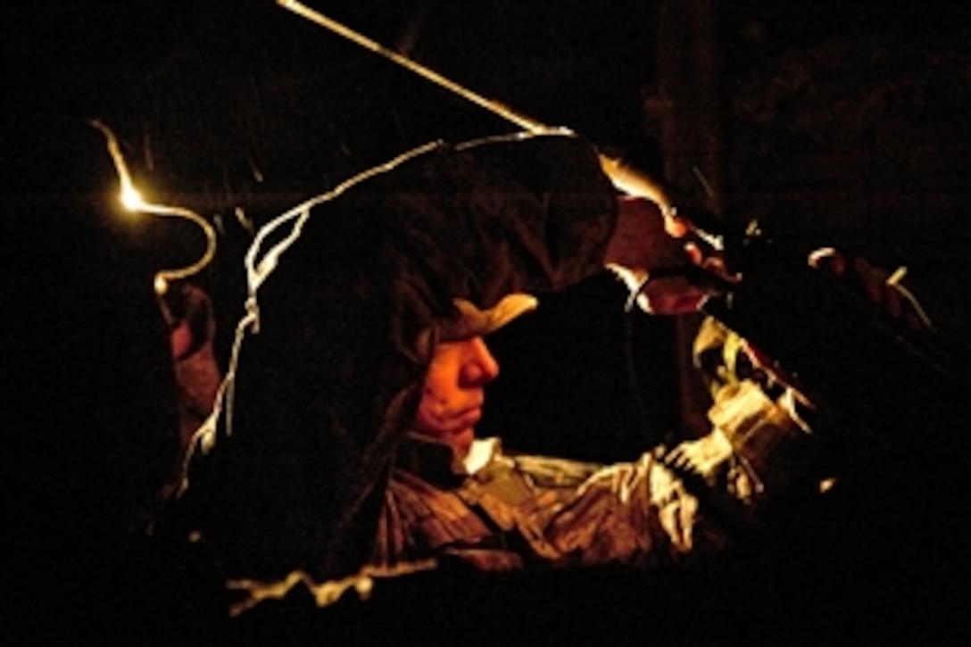 A U.S. soldier attempts to establish communication with Camp Sam Hill during Talisman Sabre 2011 at the Shoalwater Bay Training Area in Queensland, Australia, July 15, 2011. Talisman Sabre is a bilateral exercise to train U.S. and Australian forces in combined operations to improve combat readiness and interoperability.