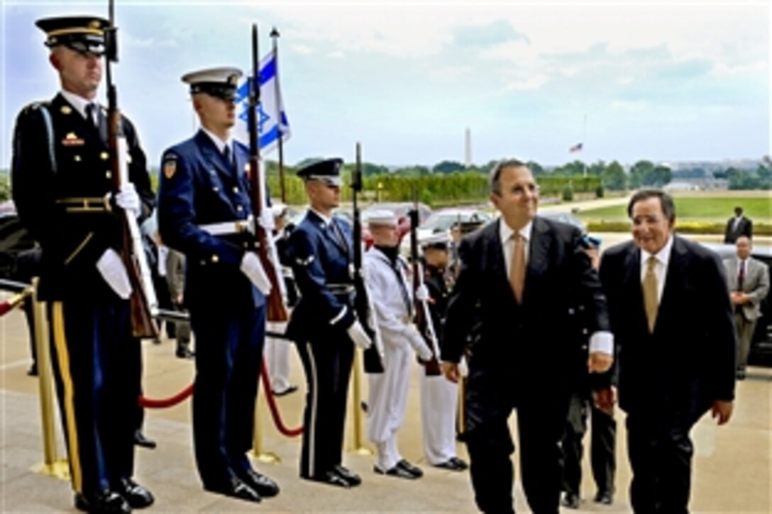 U.S. Defense Secretary Leon E. Panetta, right, escorts Israeli Defense Minister Ehud Barak through an honor cordon into the Pentagon, July 28, 2011. The two defense leaders held security talks on a range of issues.