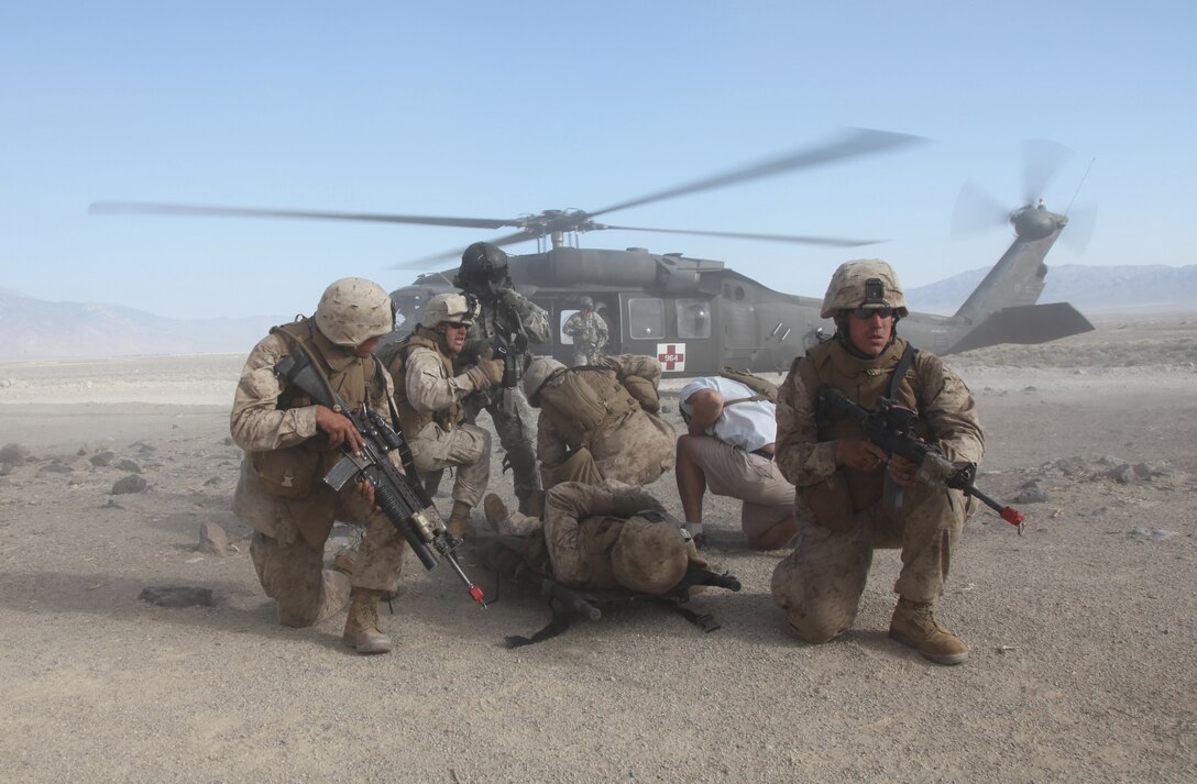 Marines with Company E, 2nd Battalion, 24th Marine Regiment, perform a medical evacuation during the final exercise of Javelin Thrust, July 28. The final exercise put the company’s new skills to the test, giving them a chance to display their capabilities.