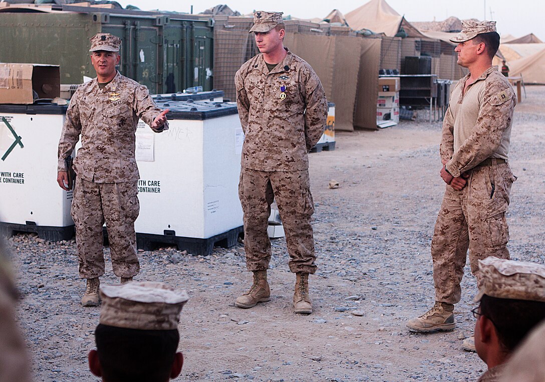 Navy Cmdr. Sean Barbabella thanks Navy Petty Officer 2nd Class Timothy Walsh after a awards ceremony here, July 28. Barbabella, a native of Smock, Penn., is the division surgeon for 2nd Marine Expeditionary Force. Walsh, a native of Weymouth, Mass., is the senior line corpsman for Charlie Company, 1st Battalion, 3rd Marine Regiment. Walsh was awarded the Purple Heart for received taken during his deployment to Helmand province in 2010. “It represents my deployment last year,” said Walsh. “All my accomplishments, all the good times and the bad times. I am honored to be awarded; to me, I wasn’t badly hurt. One of my best friends isn’t around anymore, so I view this as a way I can represent his sacrifice.” Walsh honors his friend, Navy Seaman Marc Bretmier, who died while deployed to Afghanistan in 2008.The battalion supports Regimental Combat Team 1, under 2nd Marine Division (Forward), which serves as the ground combat element in Helmand. The mission of the division is to partner with Afghan National Security Forces to conduct counterinsurgency operations to secure the Afghan people, defeat insurgent forces, and enable ANSF to assume security responsibilities in the region. Ultimately, the partnered forces promote the expansion of stability, development and legitimate governance.
